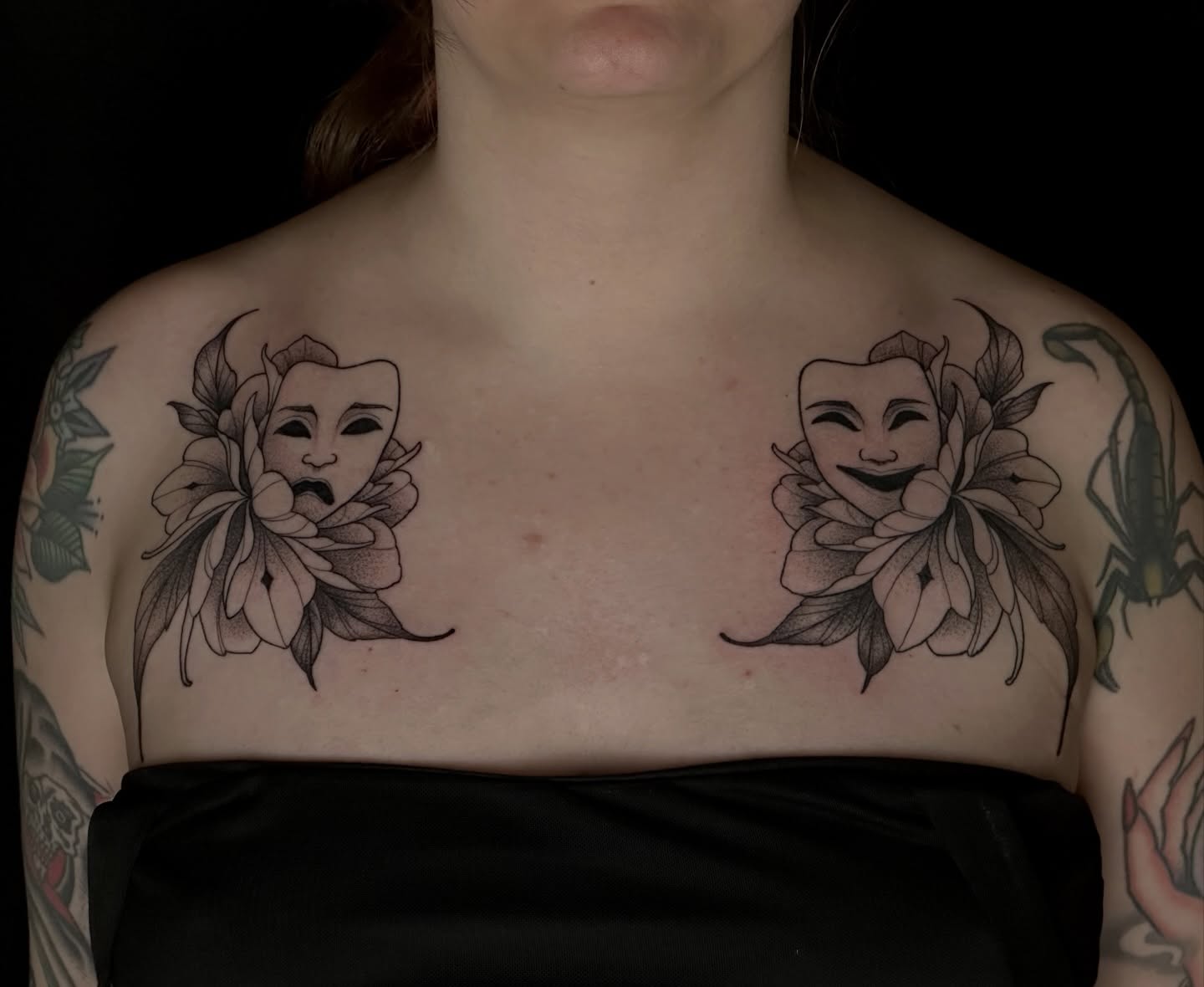 Theater masks and flowers realism tattoo on the chest by Zoe Arrigo