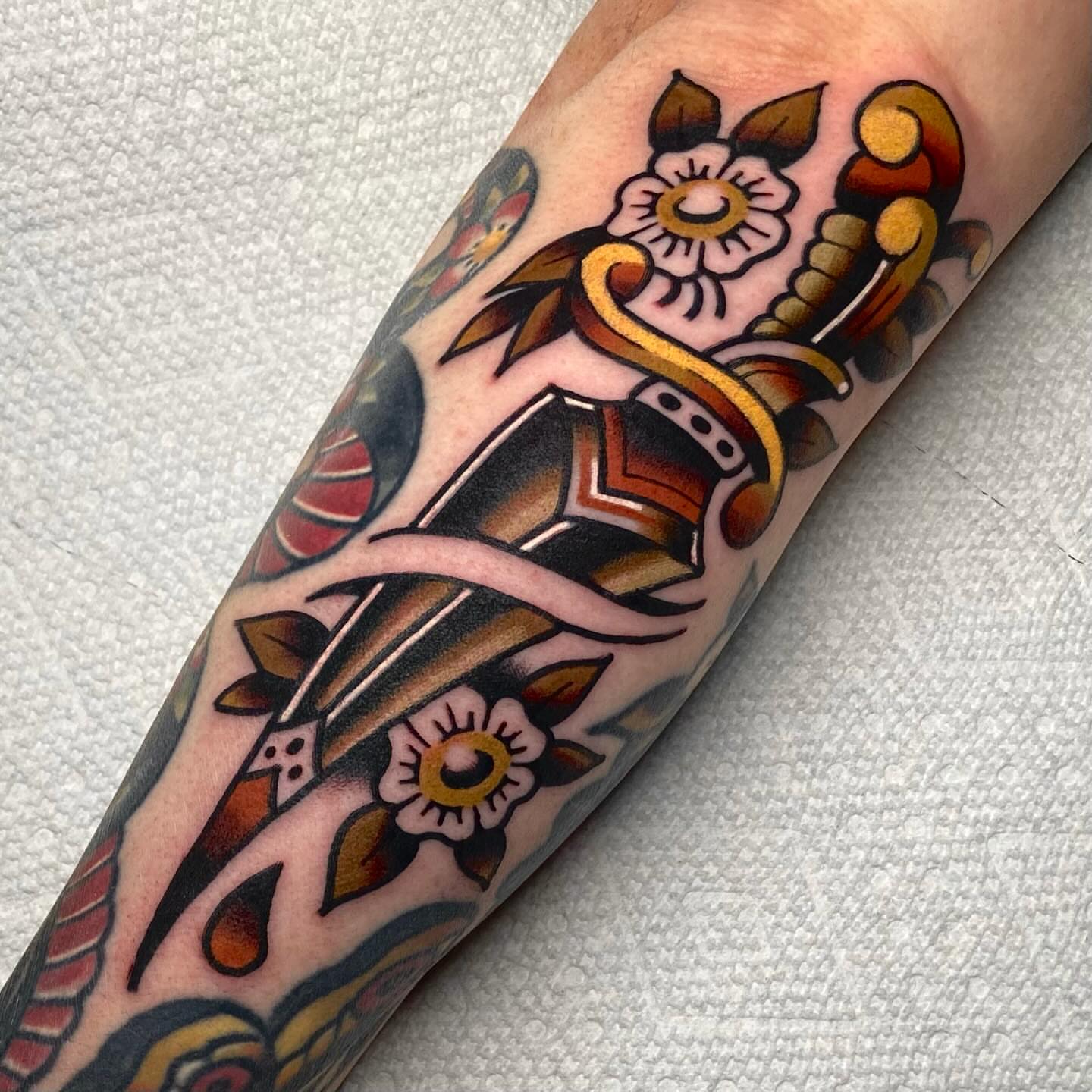 Sword and flowers American traditional tattoo on the forearm by Matthew Limbers⚜️