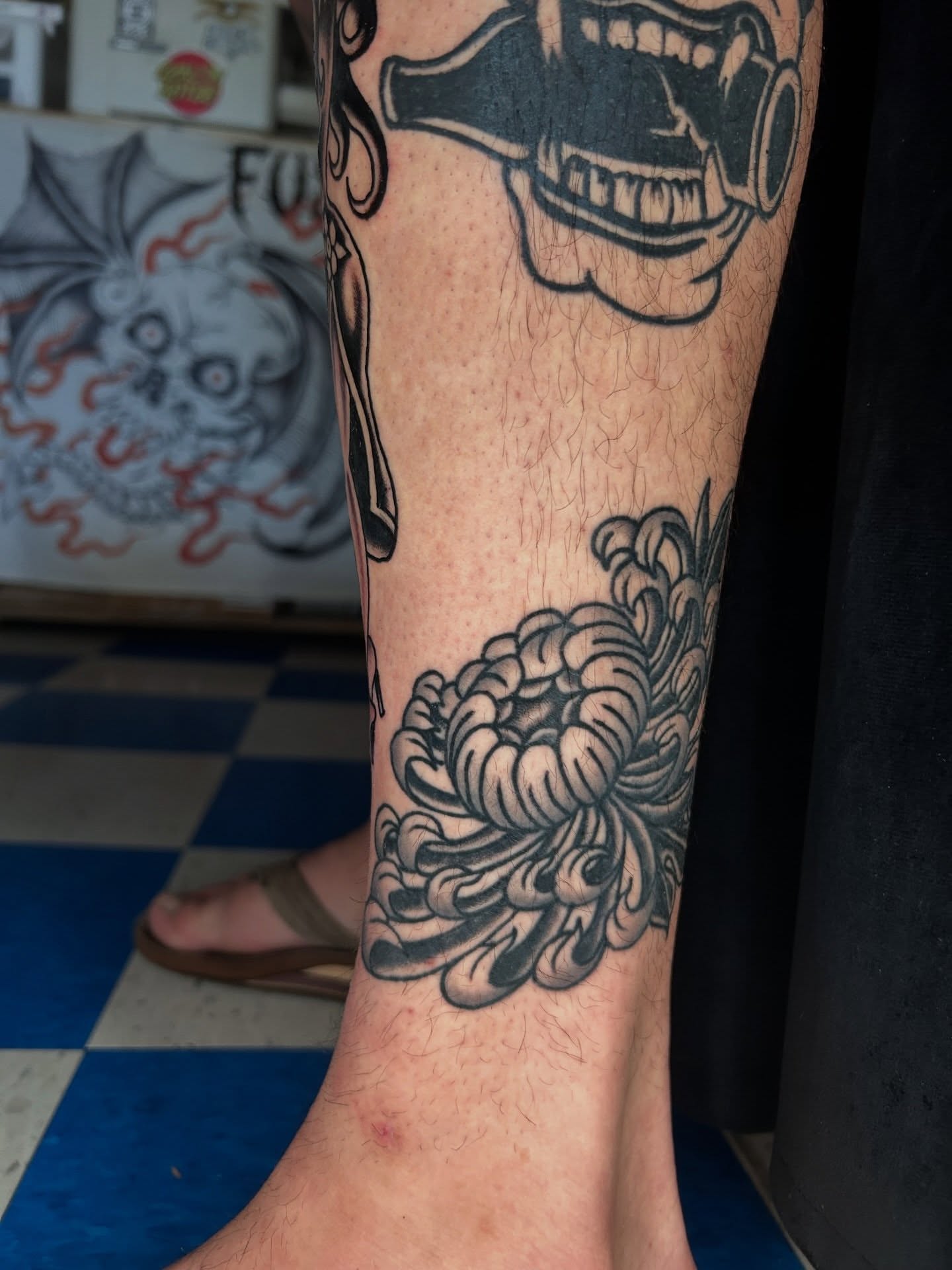 Chrysanthemum black and grey tattoo on the calf by β π€ππ©π¦π©π’π β± β