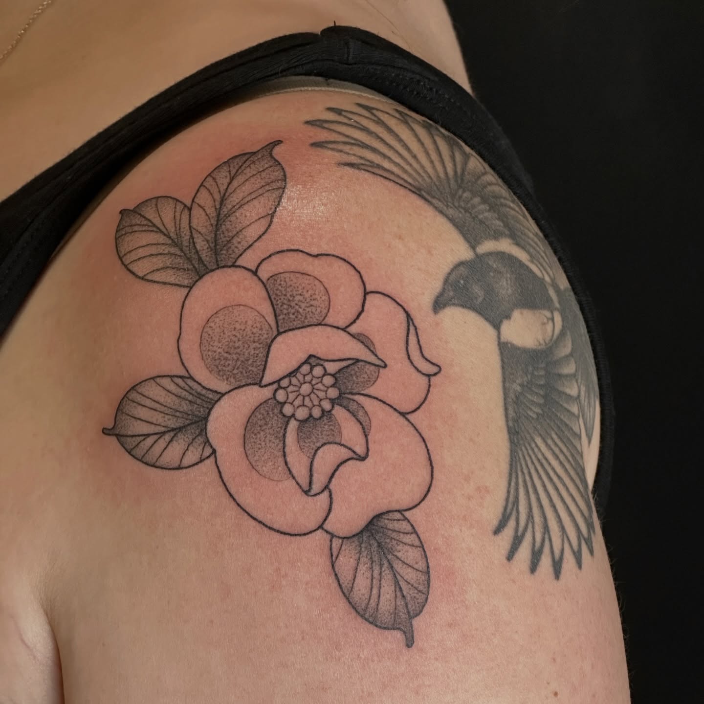 Flower and bird dotwork tattoo on the shoulder by Zoe Arrigo