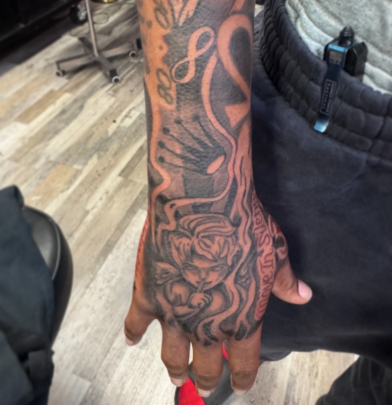Angel with musical notes realism tattoo on the hand by Tyler Cooper, Las Vegas, Nevada