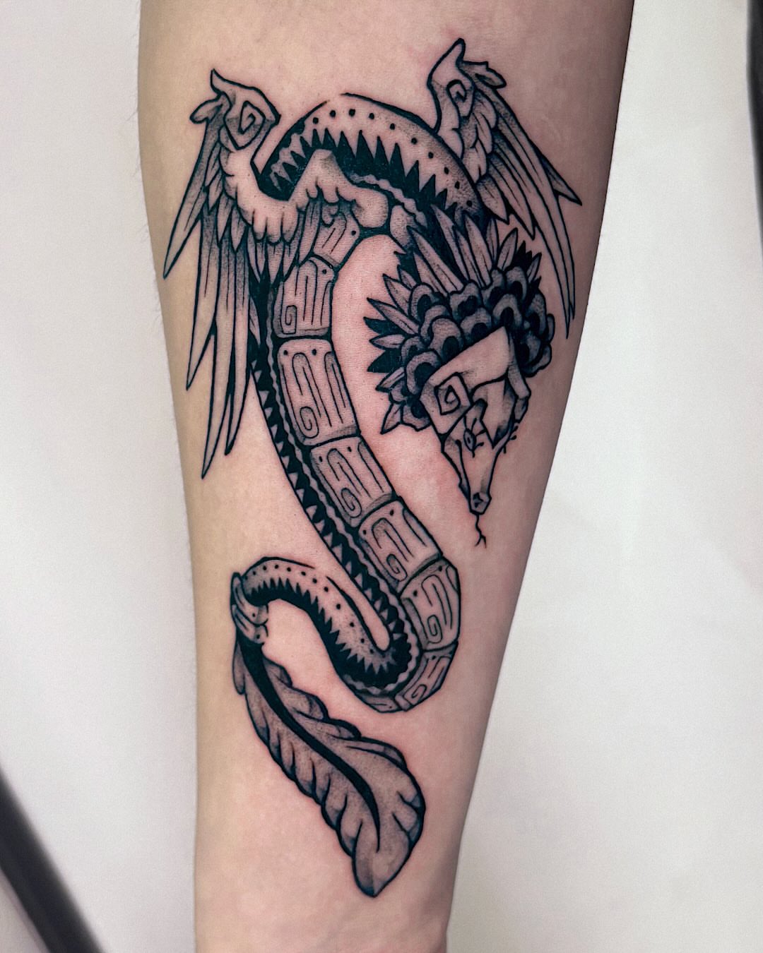 Serpent black and grey tattoo on the forearm by Kal