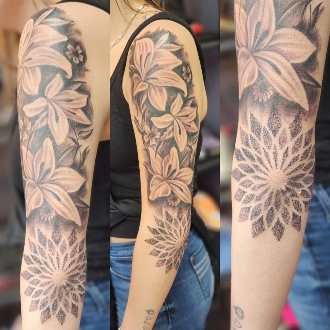 Floral sleeve with mandala geometric tattoo on the forearm by Dennis Foust