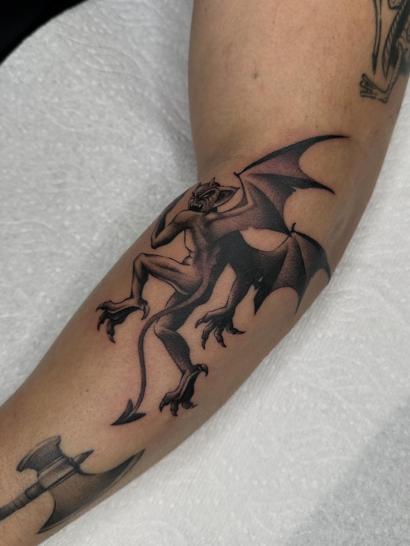 Gargoyle black and grey tattoo on the forearm by Aleksandra