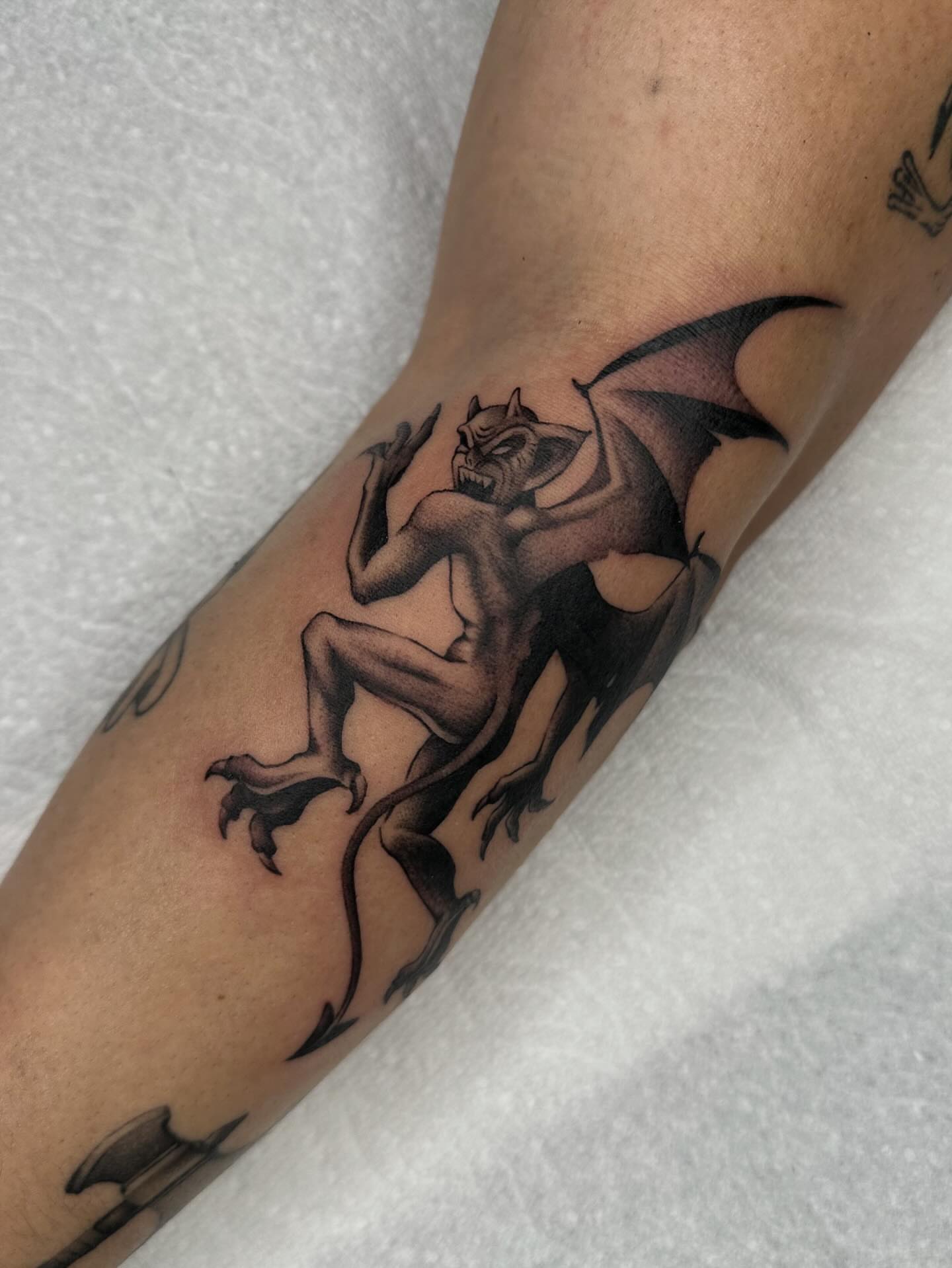 Gargoyle black and grey tattoo on the forearm by Aleksandra