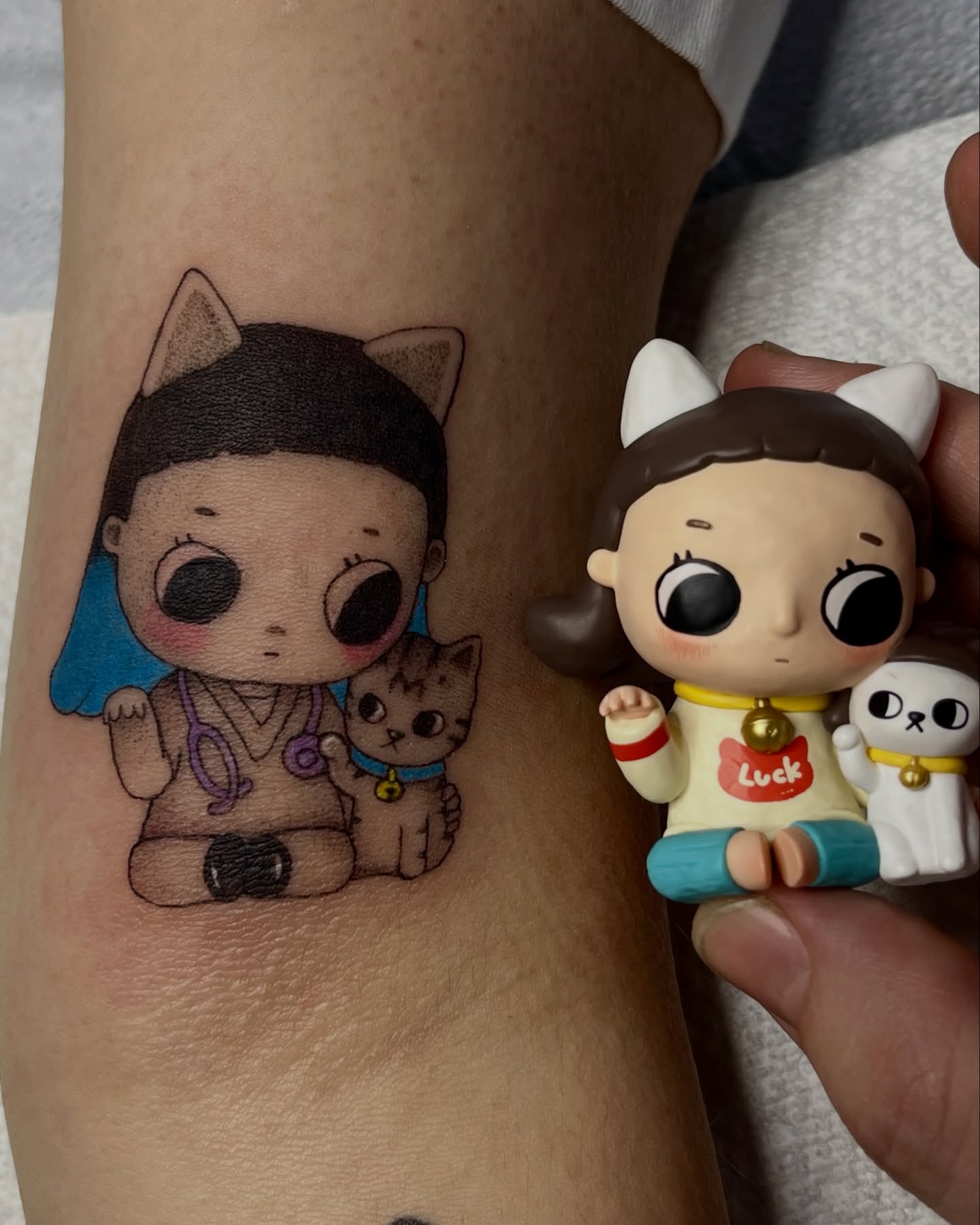 Cat and child anime tattoo on the forearm by Sarah Jurgielewicz