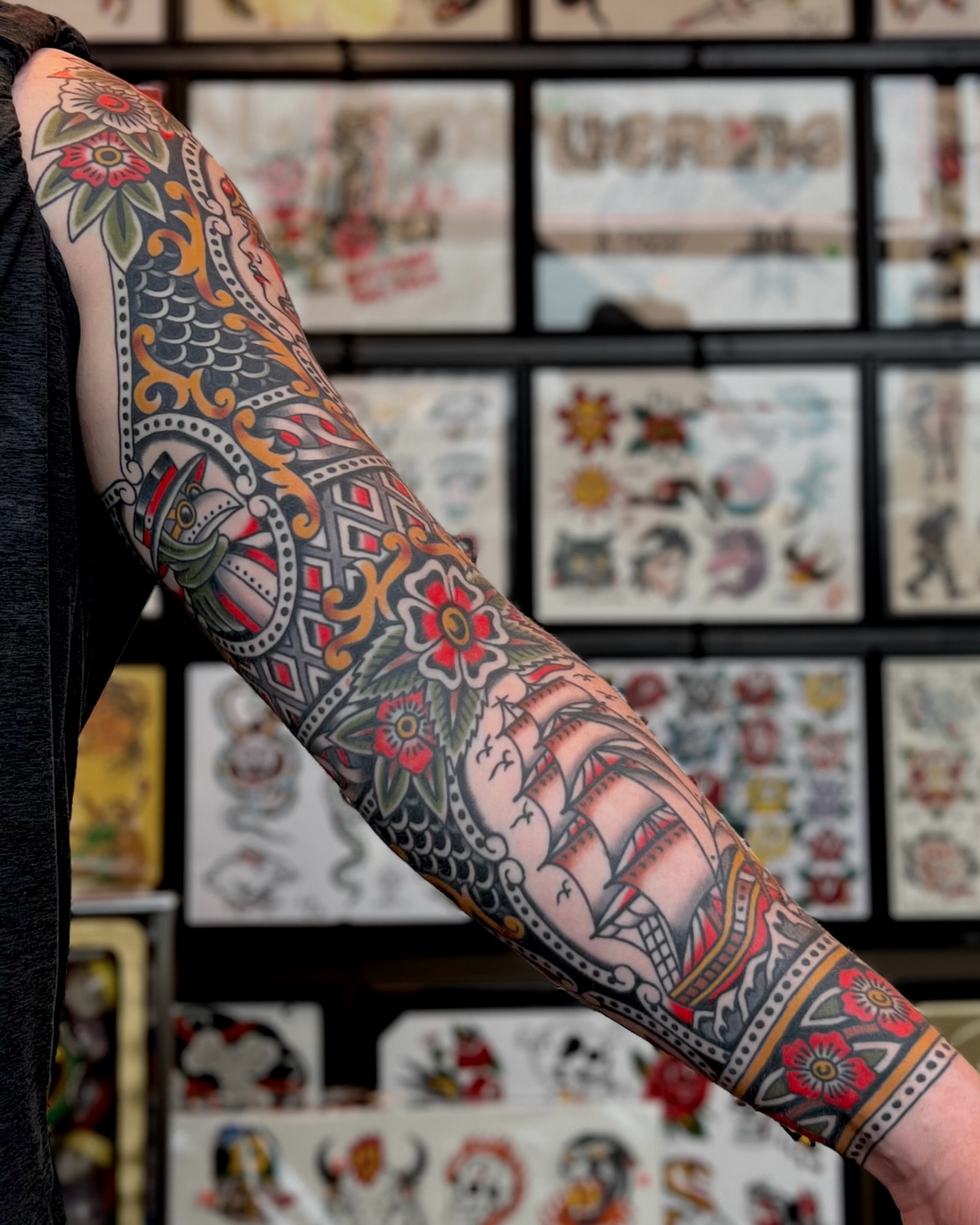 Sailboat and floral American traditional tattoo on the forearm by Brian Visser