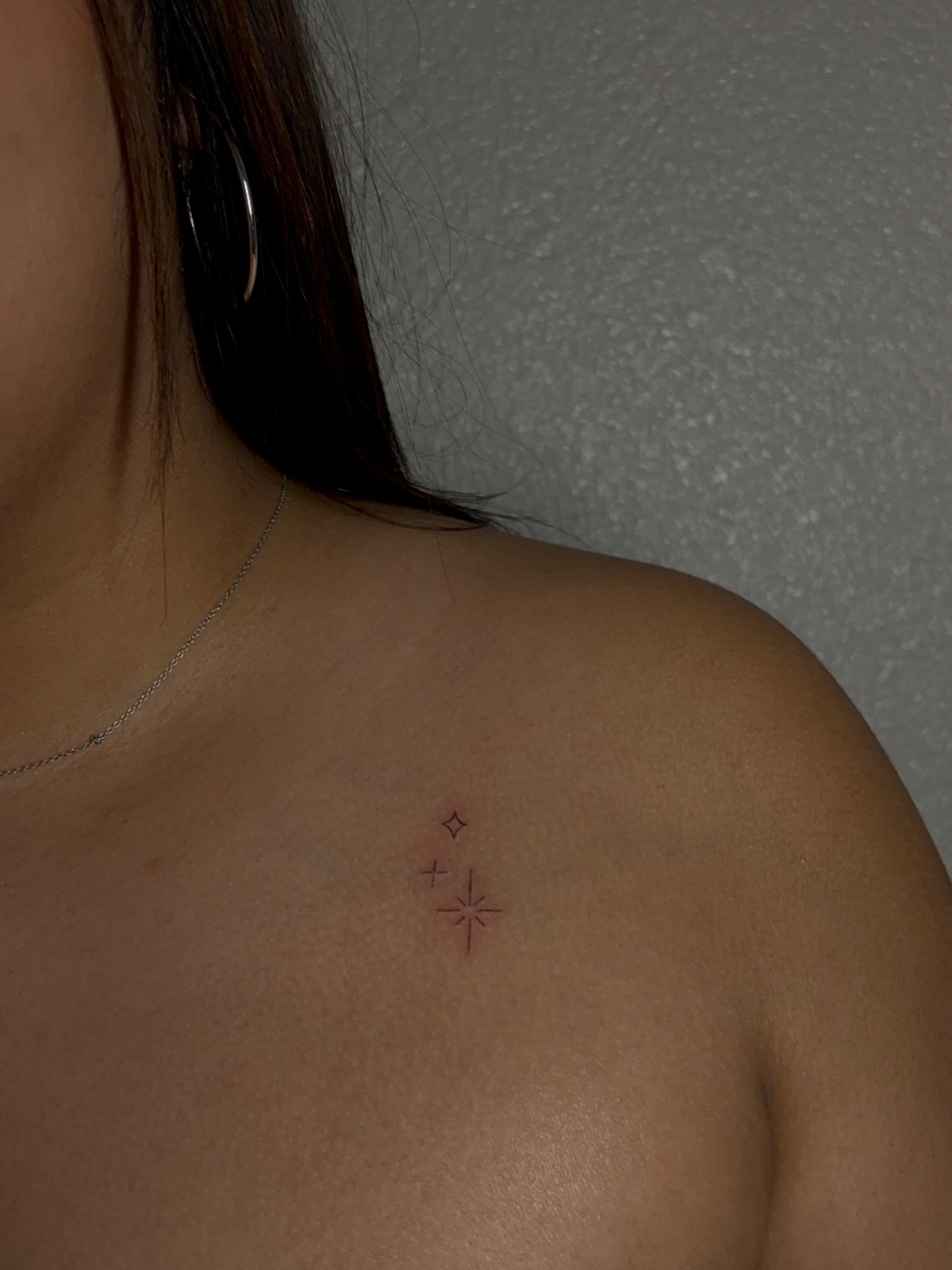 Cross and stars geometric tattoo on the shoulder by Valentina