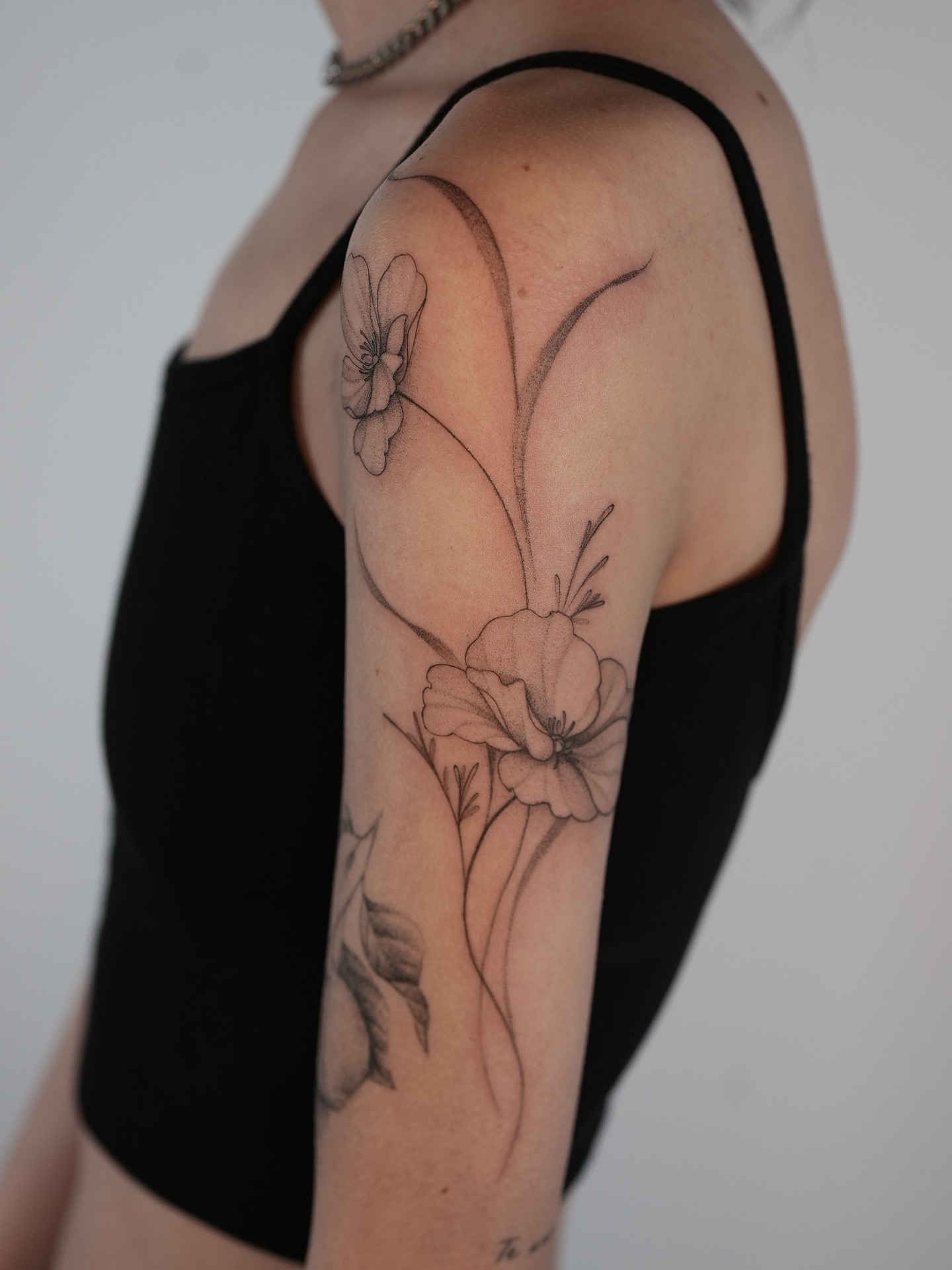 Flowers realism tattoo on the upper arm by X