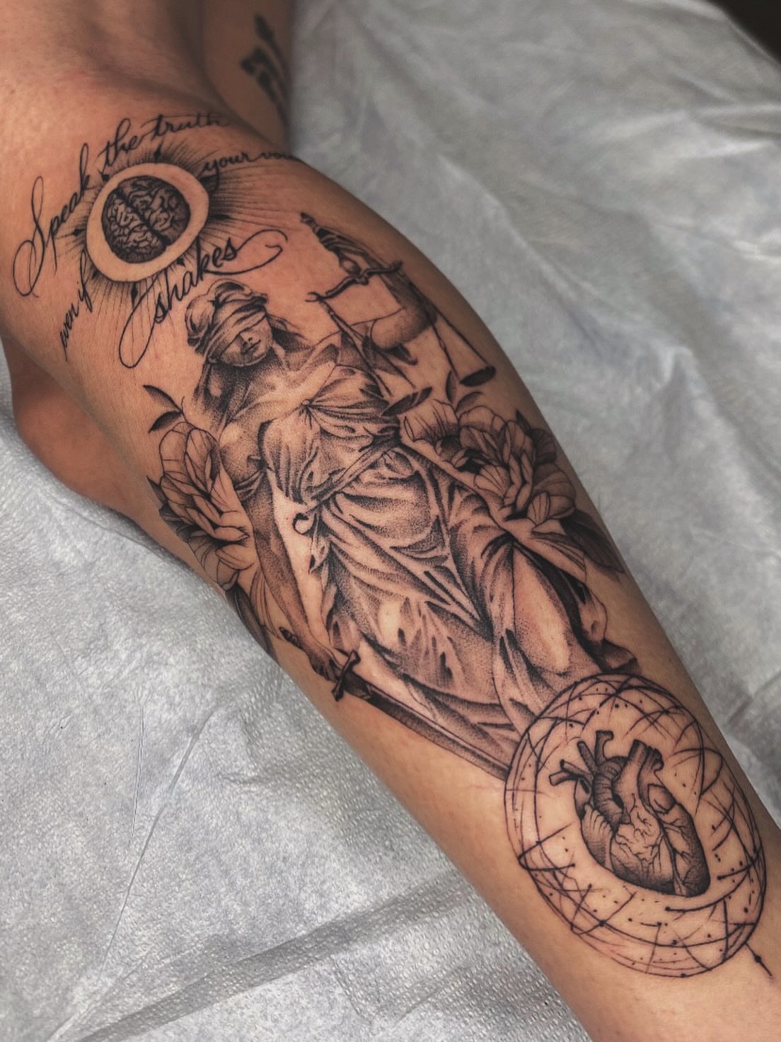 Statue with flowers realism tattoo on the forearm by Cody Mason