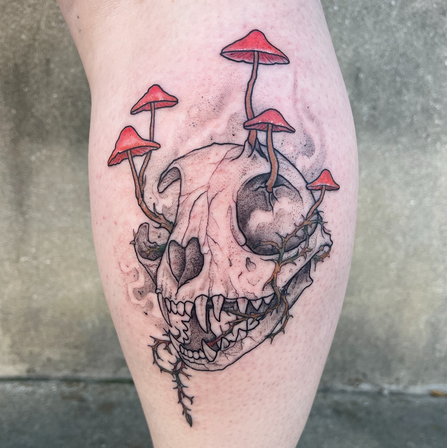 Skull with mushrooms dark realism tattoo on the thigh by Timmy