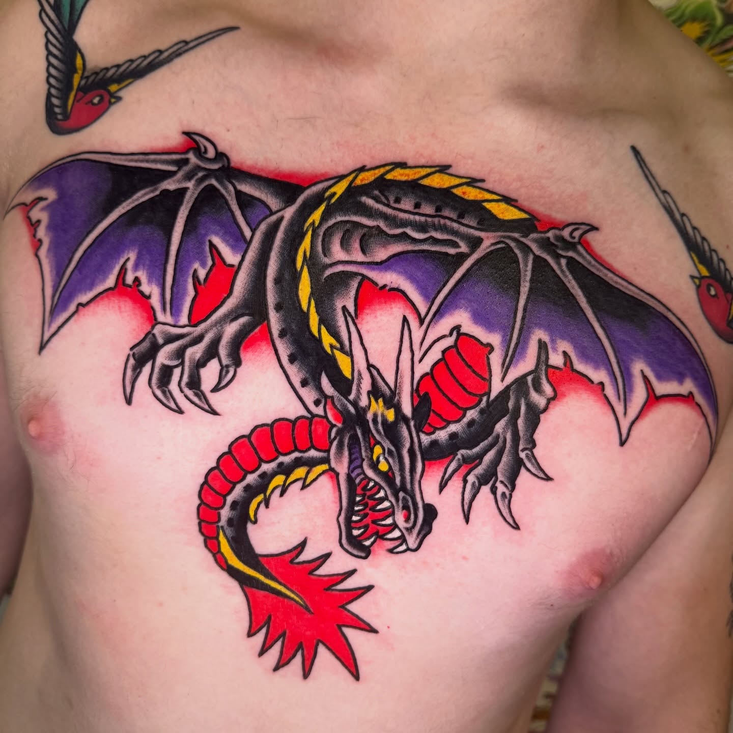 Dragon American traditional tattoo on the chest by Mike Dunn
