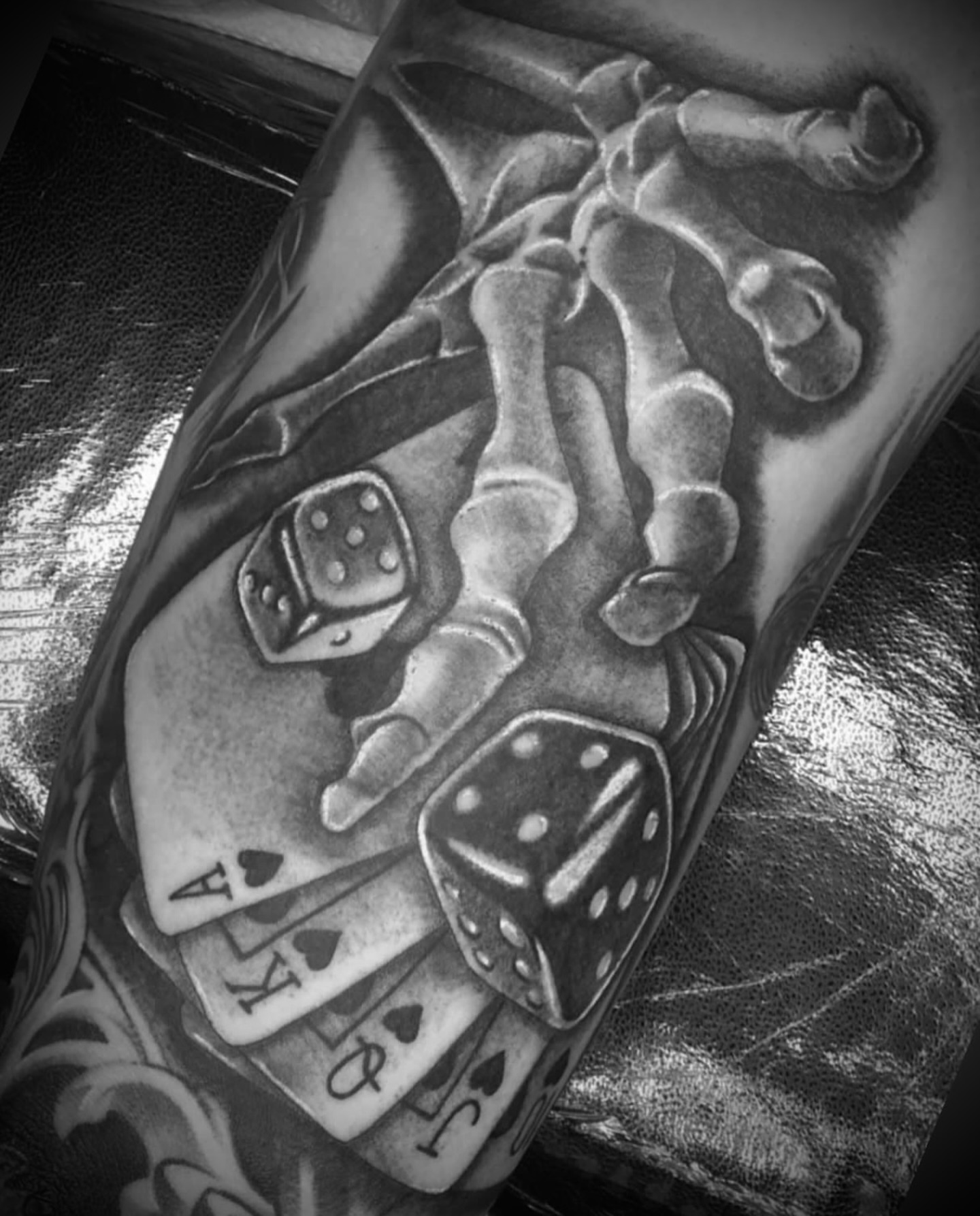 Playing cards and dice realism tattoo on the forearm by Big Steve Lewis