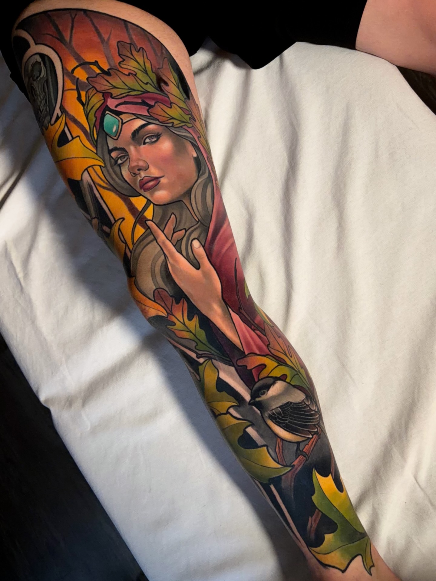 Woman with autumn leaves new school tattoo on the forearm by Milo Alfring Tattoo