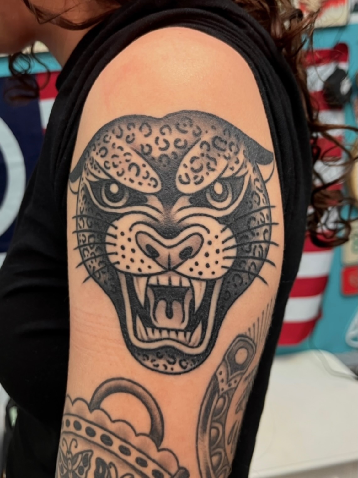 Panther head American traditional tattoo on the forearm by Macy Bird