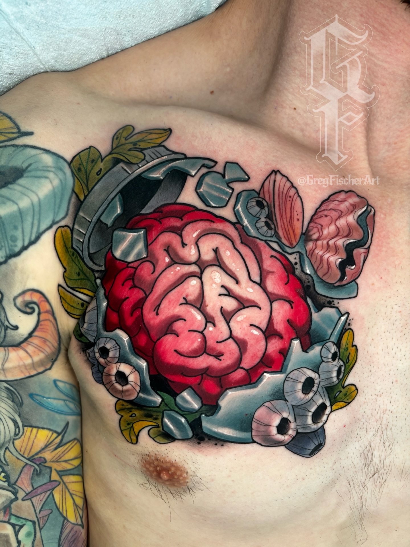 Brain neo-traditional tattoo on the chest by Greg Fischer