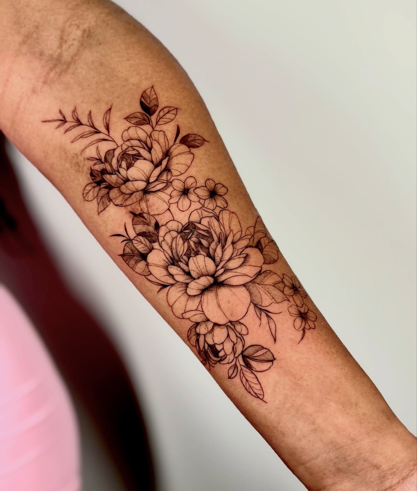 Floral bouquet black and grey tattoo on the forearm by Orca