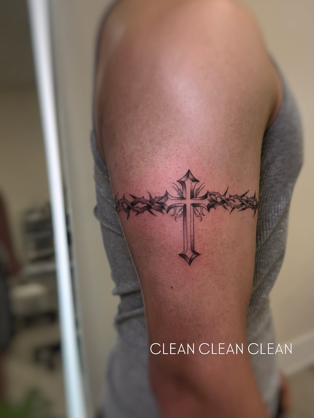 Cross with crown of thorns tattoo on the forearm by David