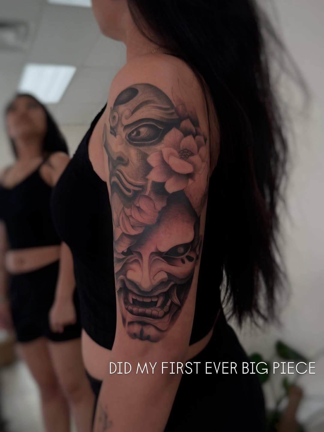 Japanese masks and flowers Japanese tattoo on the upper arm by David