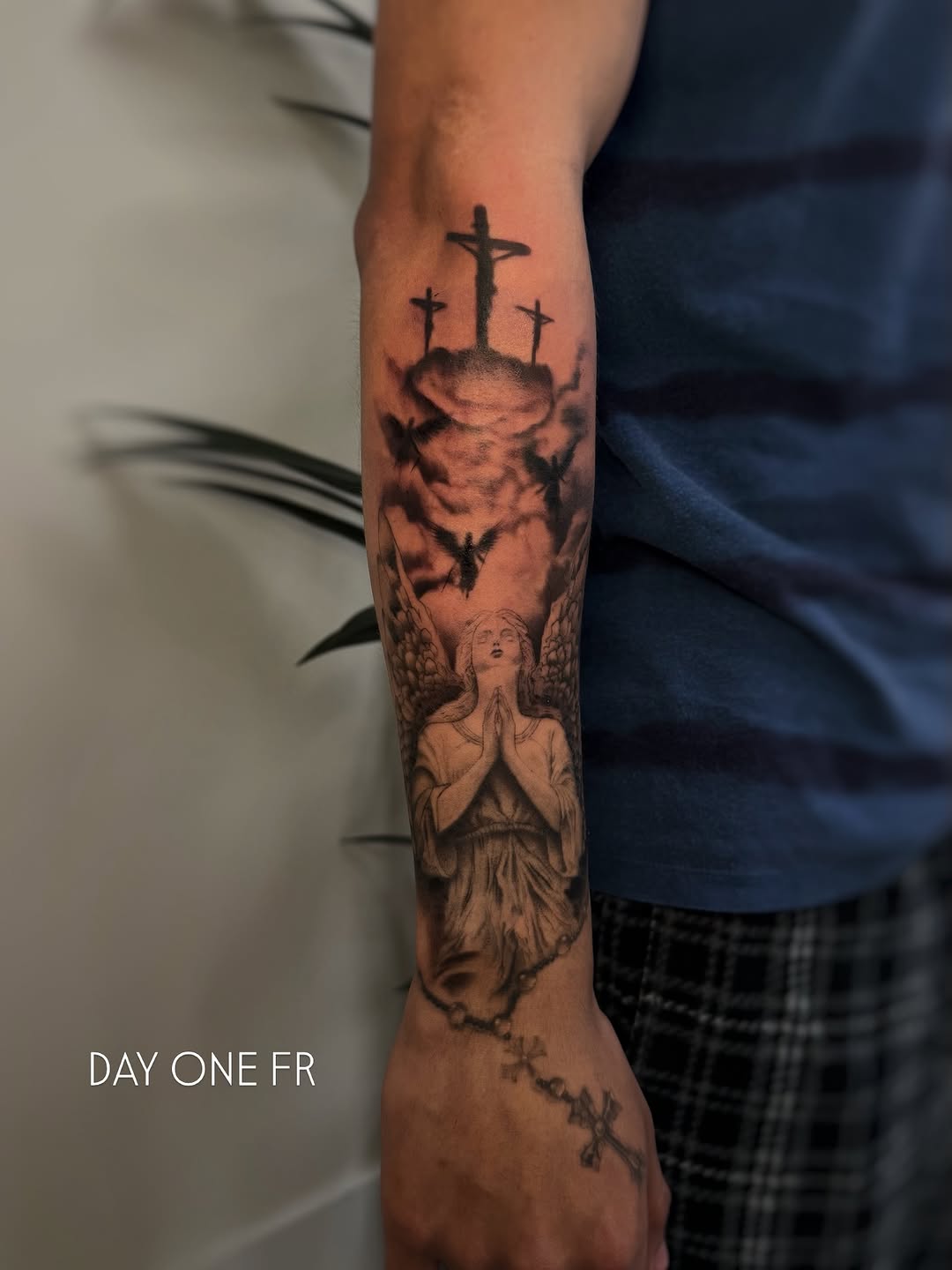 Angel and crucifixions realism tattoo on the forearm by David
