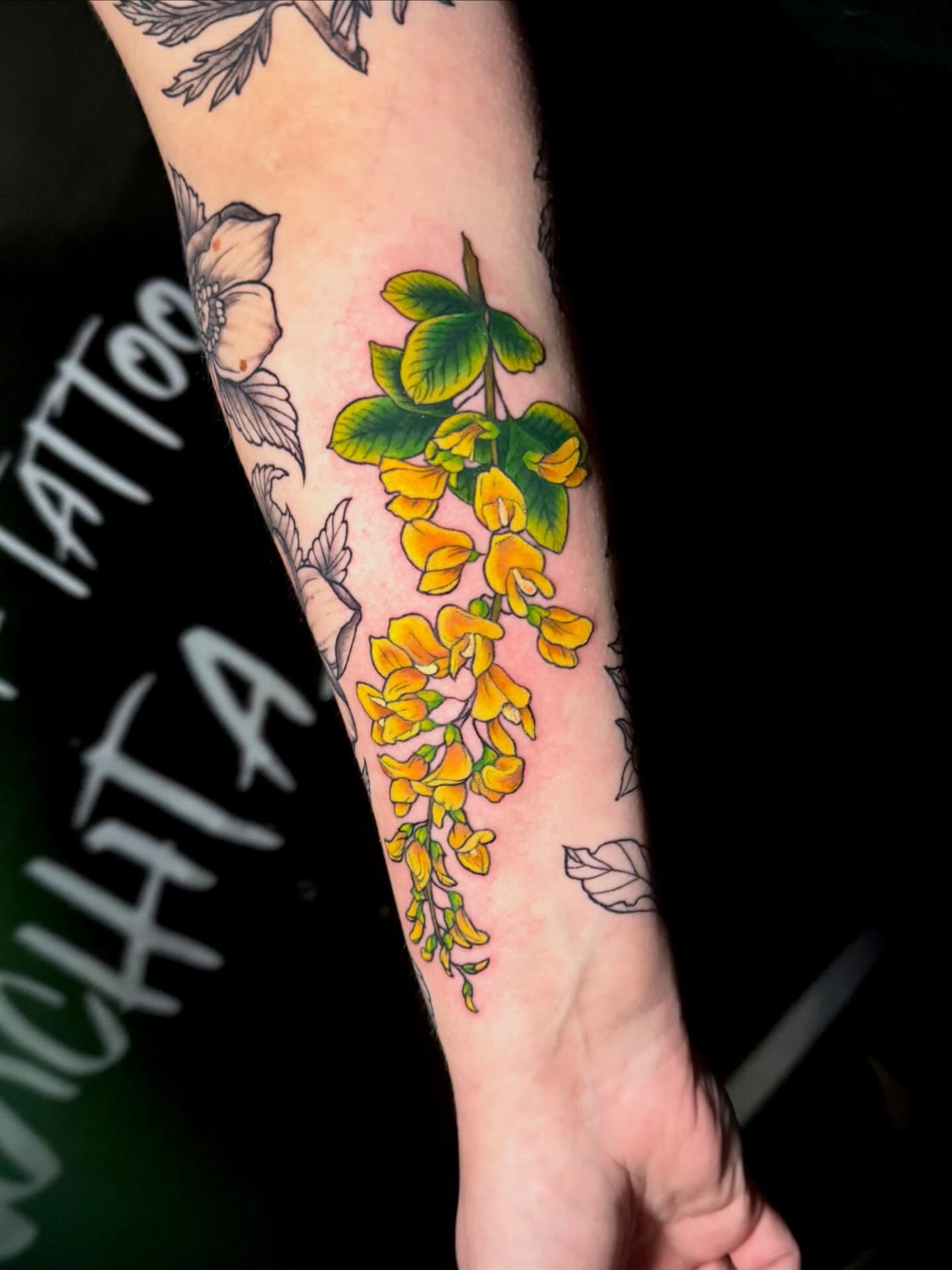 Yellow flowers realism tattoo on the forearm by Taylor Kay 🌿