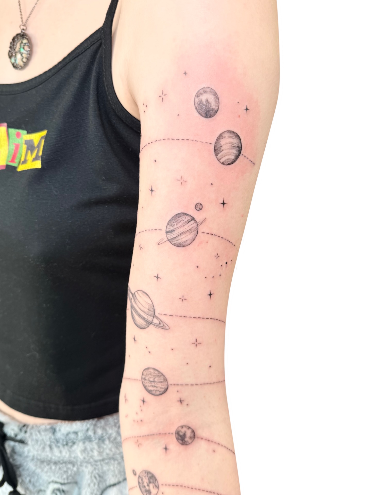 Planets and stars dotwork tattoo on the forearm by Fionna, Seattle, Washington