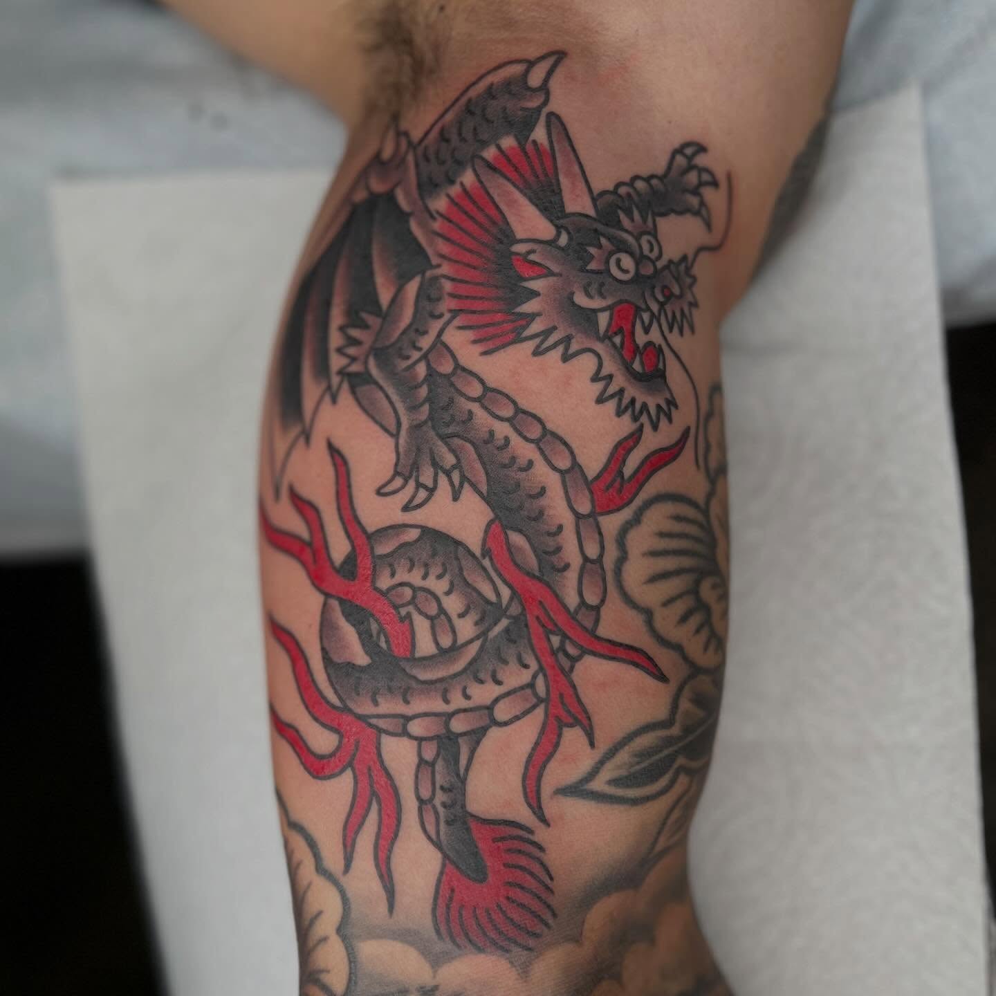 Dragon American traditional tattoo on the forearm by Mikey Montoya