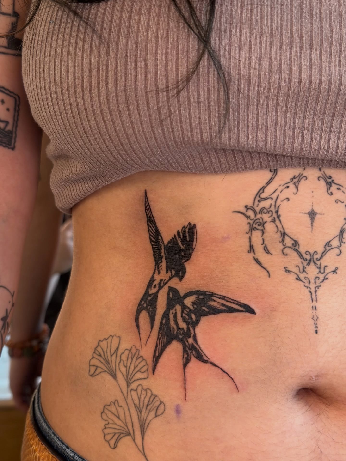 Swallows and floral black and grey tattoo on the ribs by Alaska