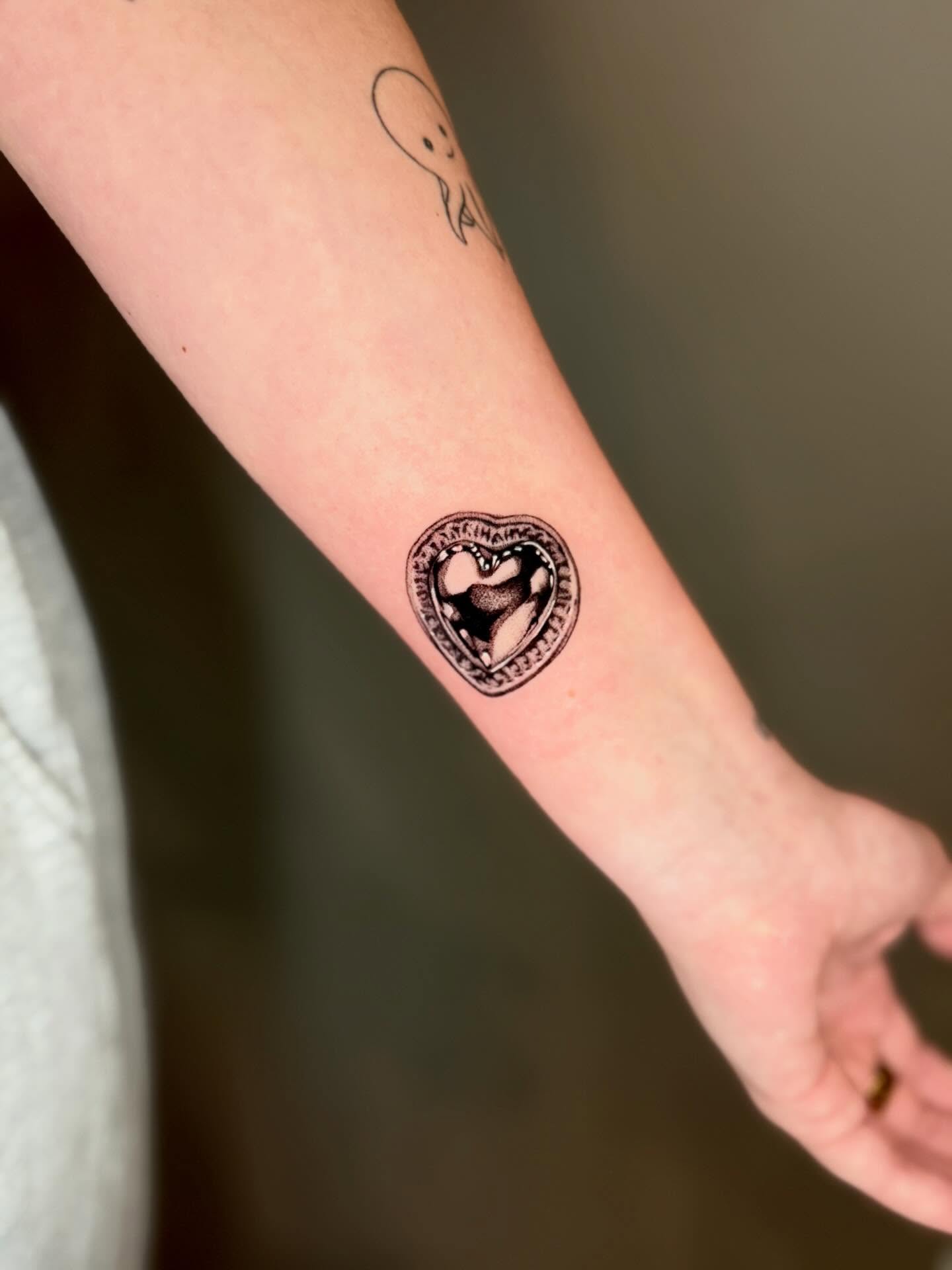 Heart black and grey tattoo on the forearm by Amber Starr, Midvale, Utah