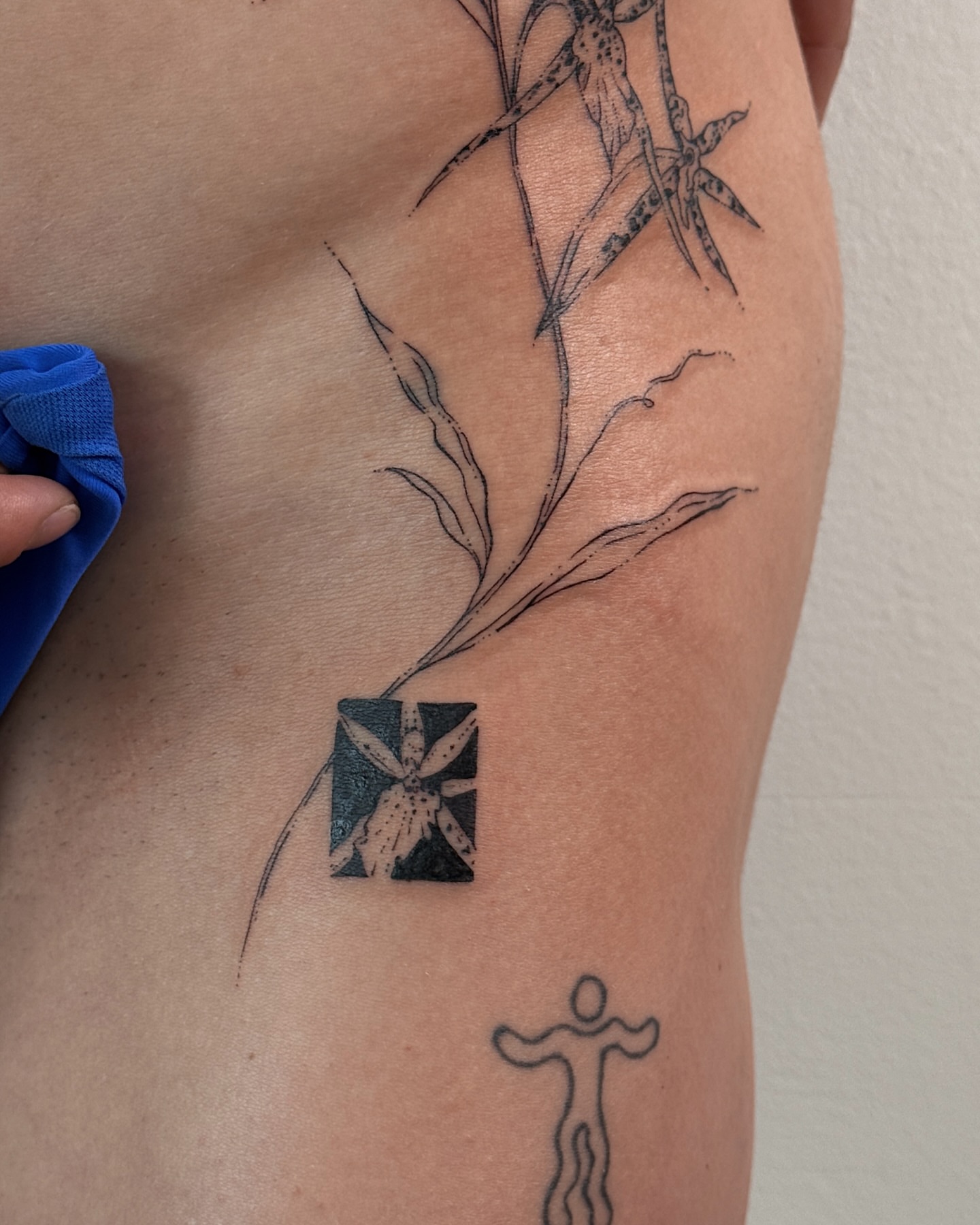 Bamboo and flower black and grey tattoo on the thigh by Inky Apricot, Austin, Texas