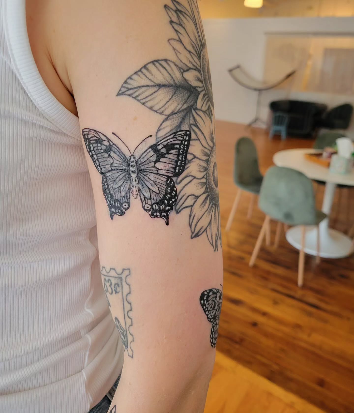 Butterfly and sunflower black and grey tattoo on the forearm by Solstice Tattoos by Savannah Sadler (future, Salisbury, North Carolina