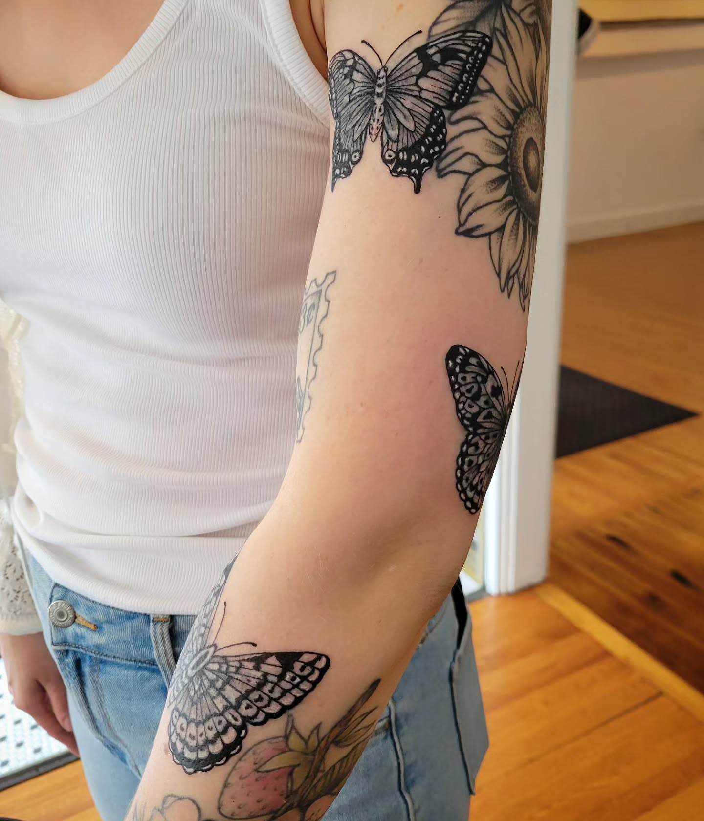 Butterflies and flowers black and grey tattoo on the forearm by Solstice Tattoos by Savannah Sadler (future, Salisbury, North Carolina