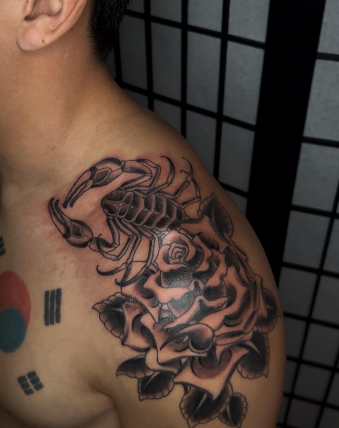 Scorpion and rose realism tattoo on the shoulder by Vic Merkley