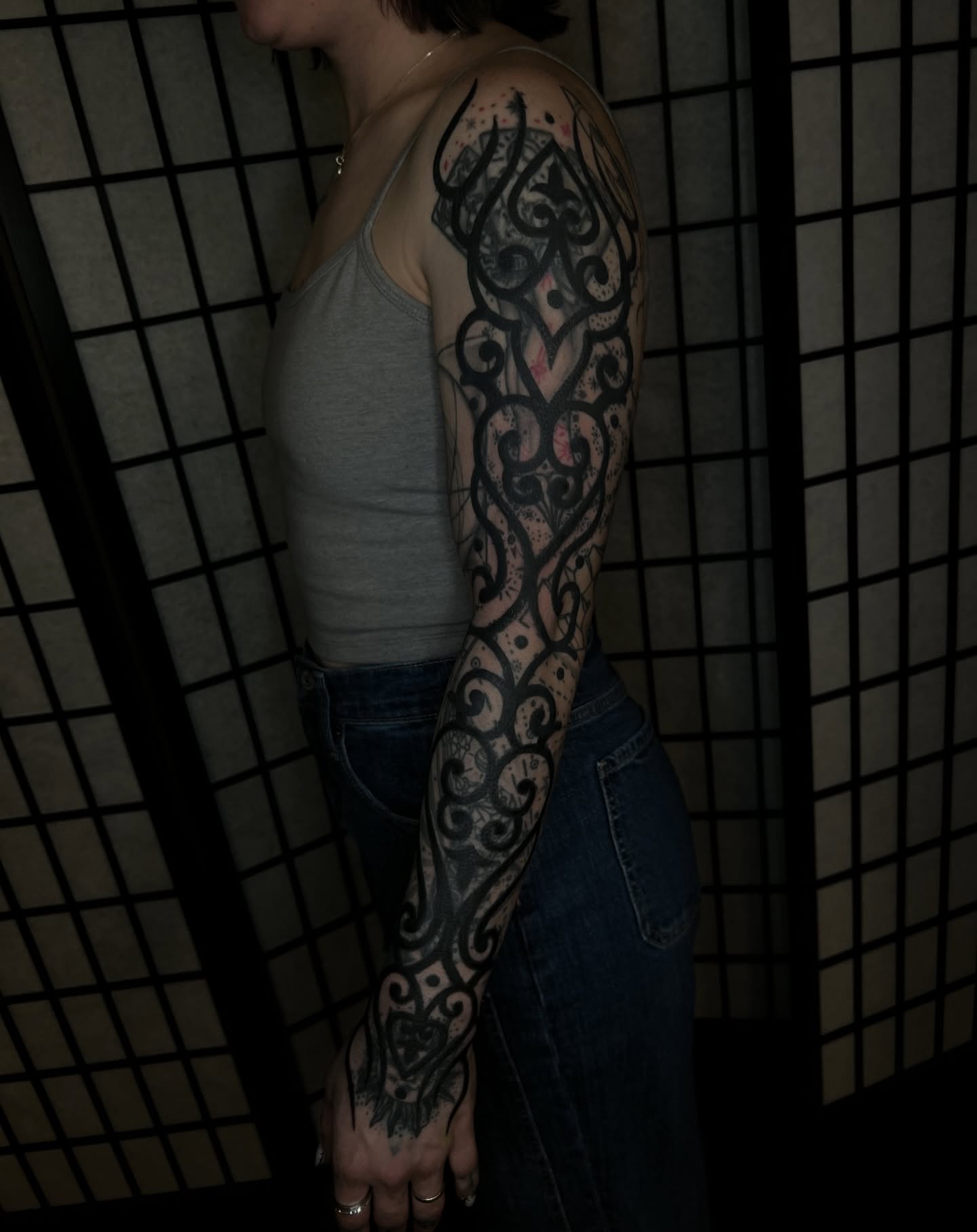 Scrollwork ornamental tattoo on the upper arm by Vic Merkley