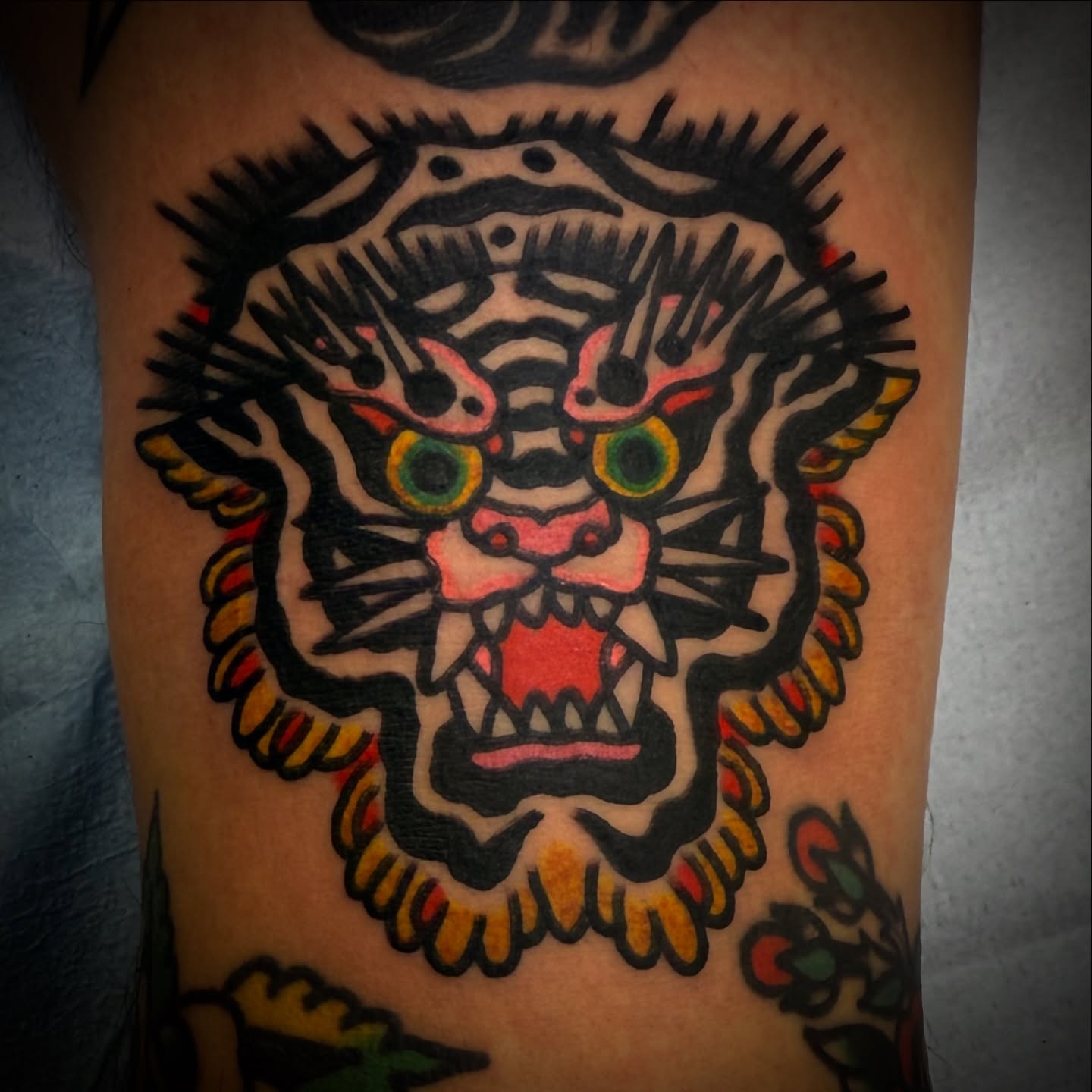 Tiger American traditional tattoo on the thigh by Chuck Paprocki, Nashville, Tennessee