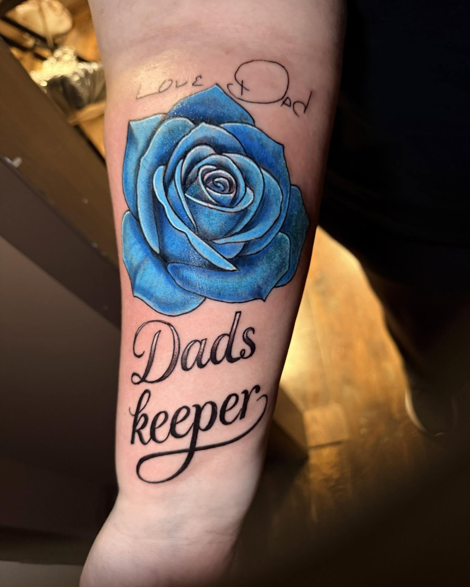 Blue rose realism tattoo on the forearm by Zacharee Osborn