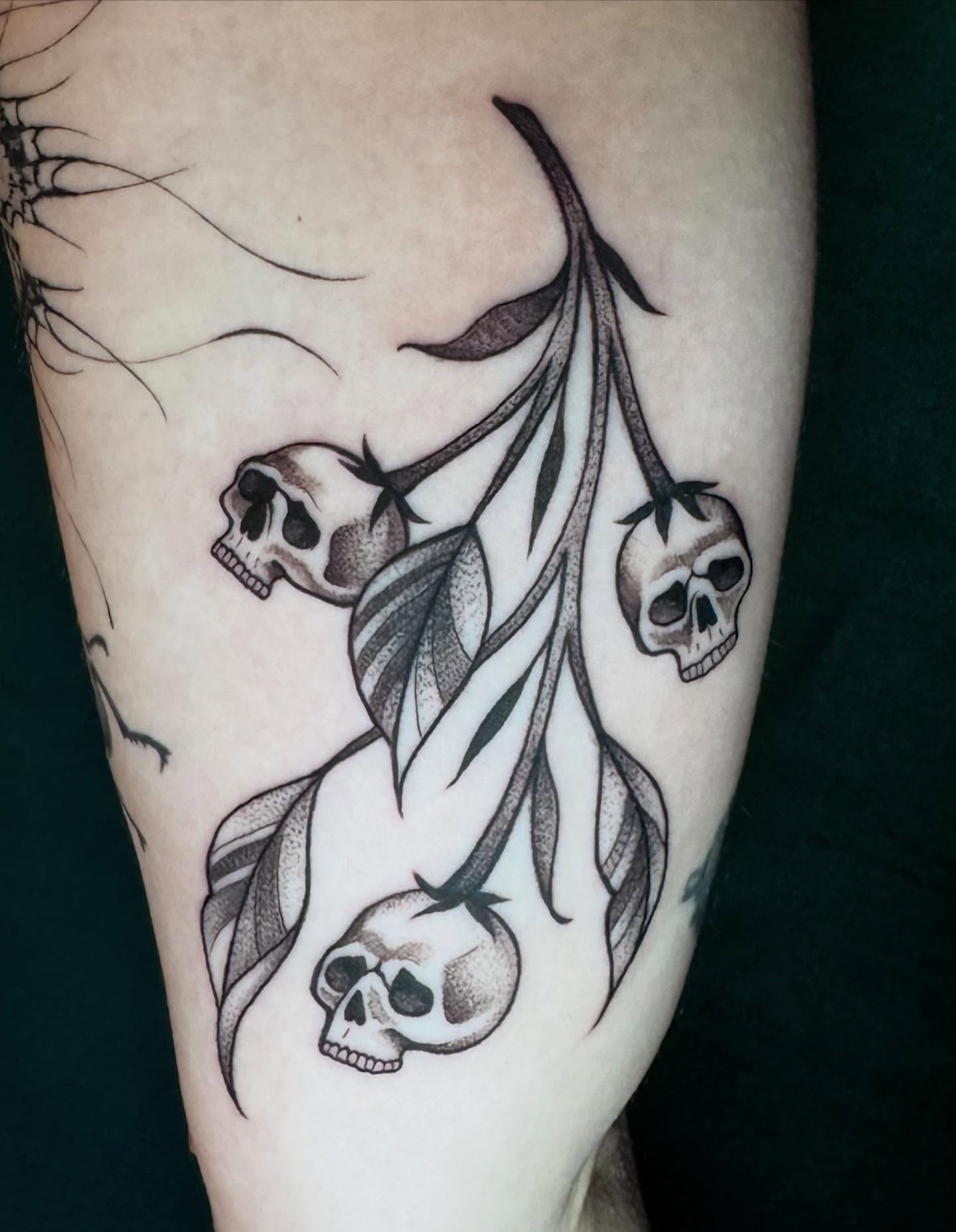 Skulls and leaves dotwork tattoo on the forearm by Morgan Peeples