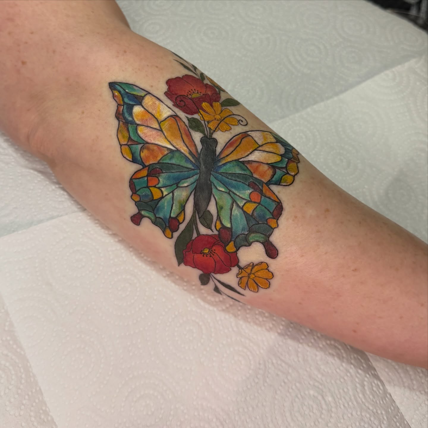 Stained glass butterfly geometric tattoo on the forearm by Dani Fried Tattoos