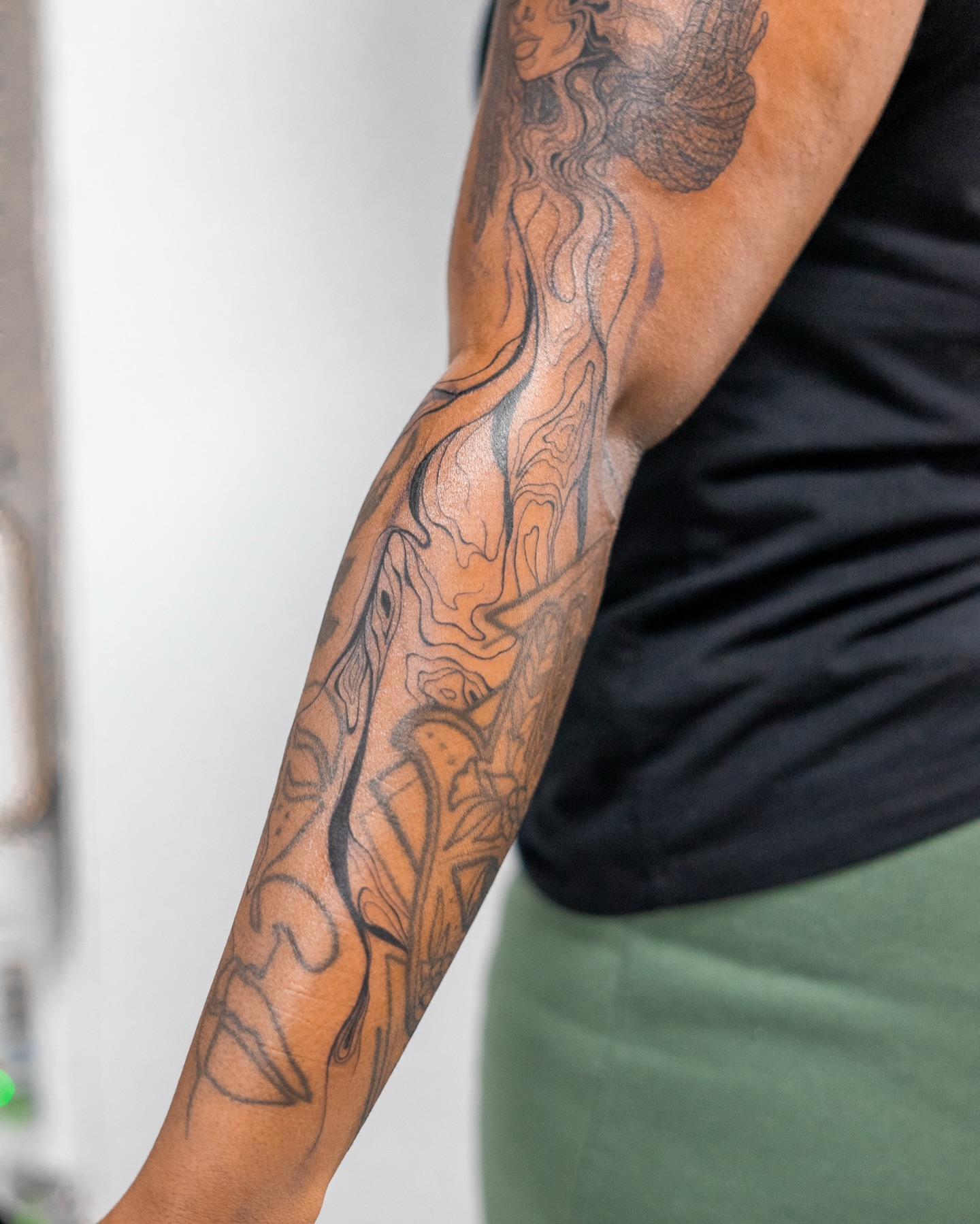 Flames and abstract shapes geometric tattoo on the forearm by The Tattoo Plug