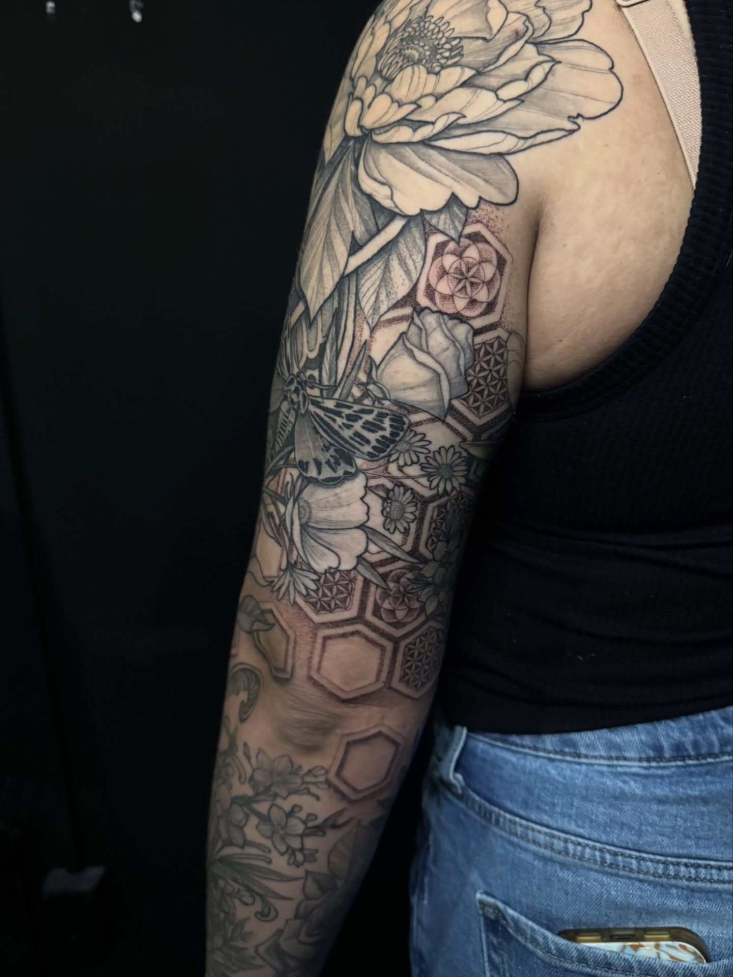 Floral arrangement geometric tattoo on the forearm by Caleb Gesicki