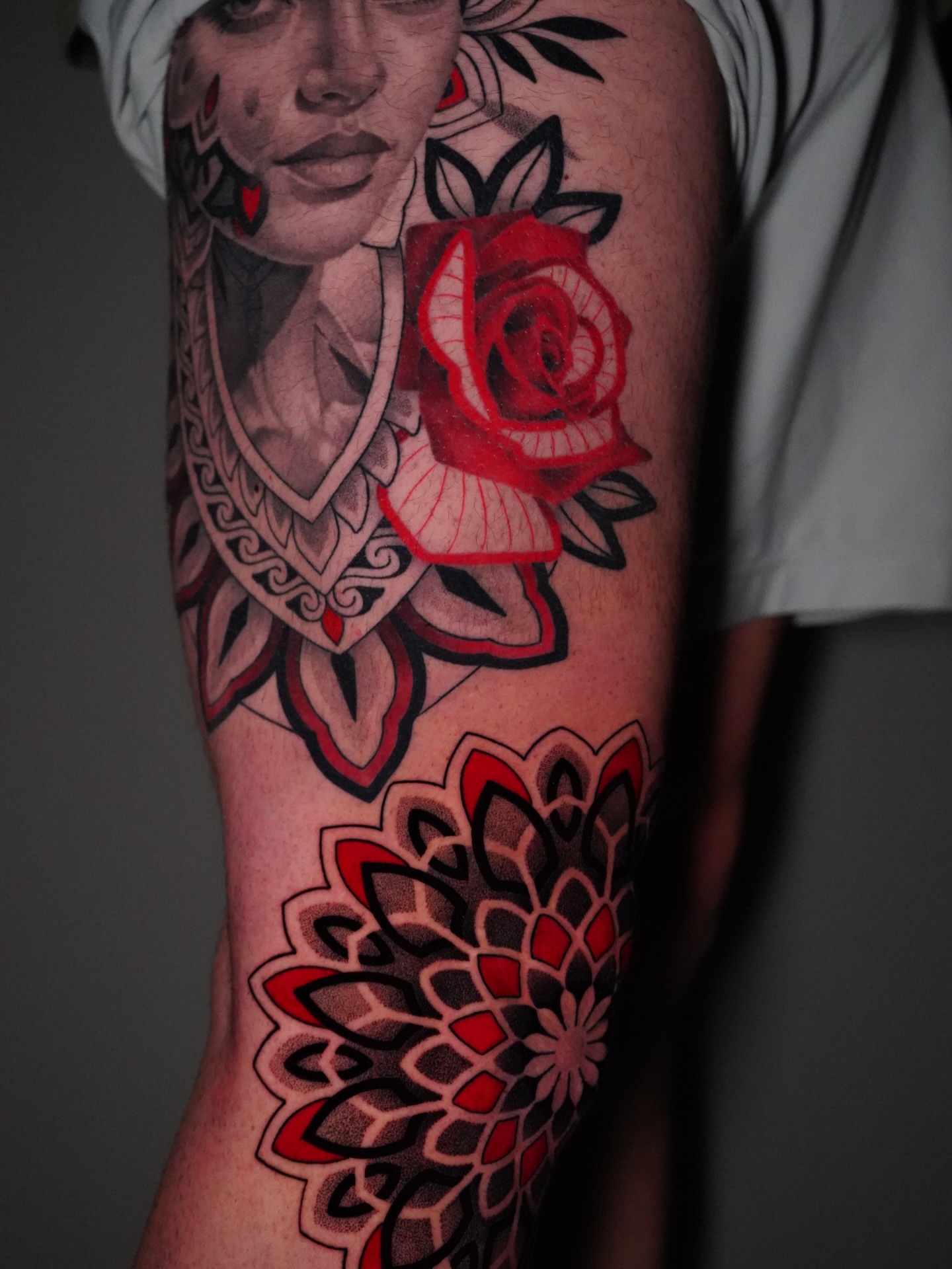 Woman with red rose American traditional tattoo on the forearm by Jason Call