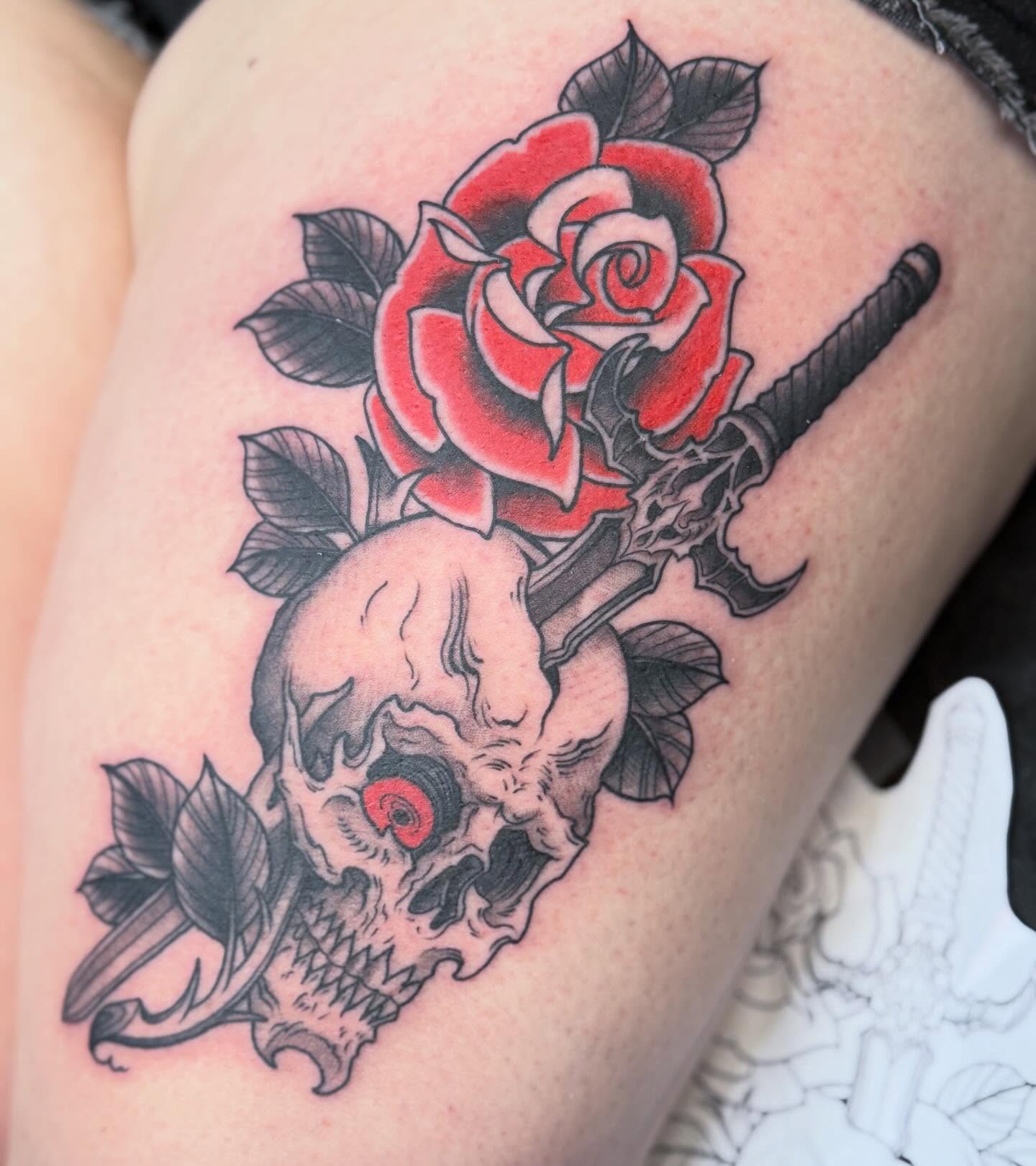 Red rose and skull American traditional tattoo on the thigh by Chase Martines