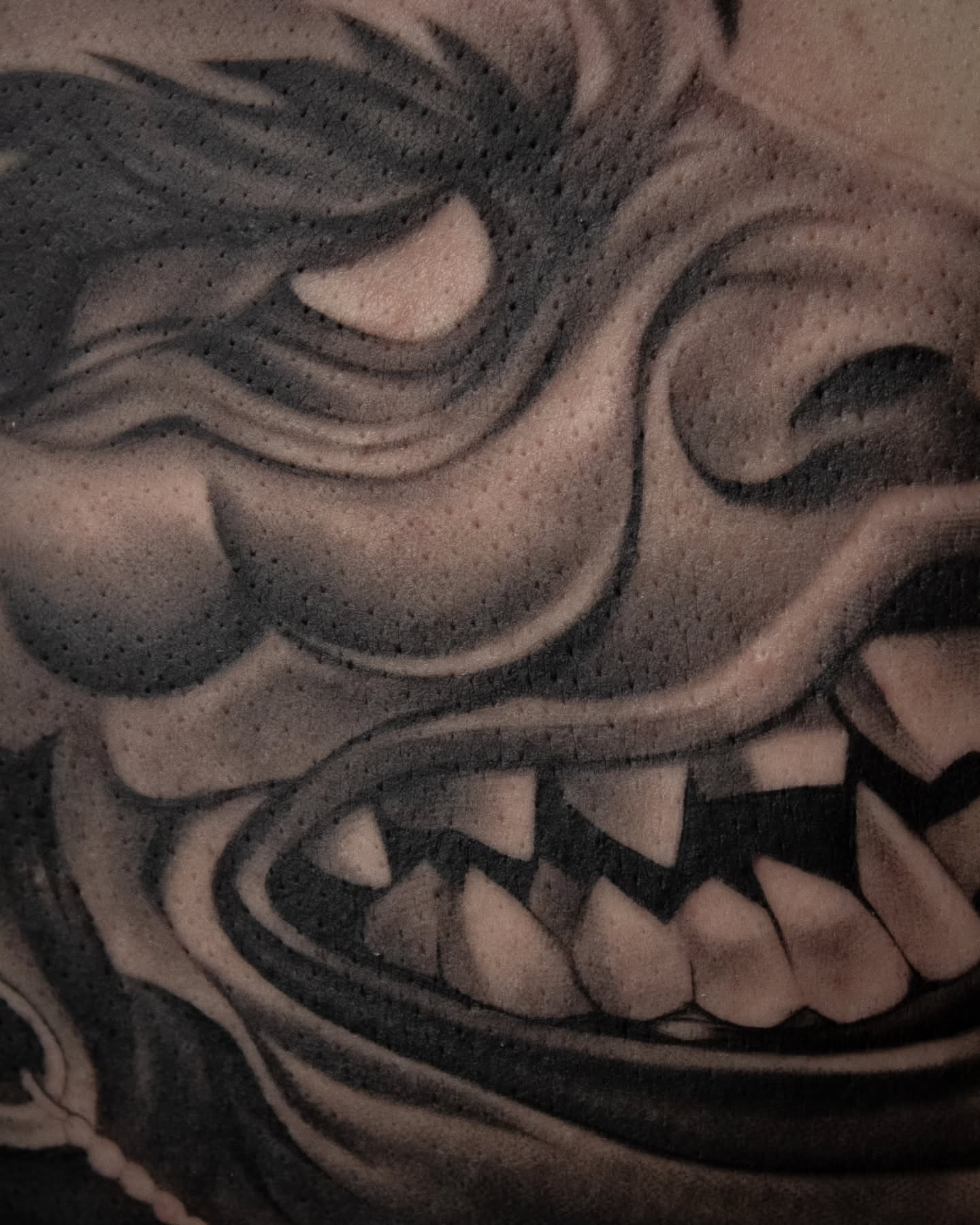 Demon face black and grey tattoo by Erik Bonilla