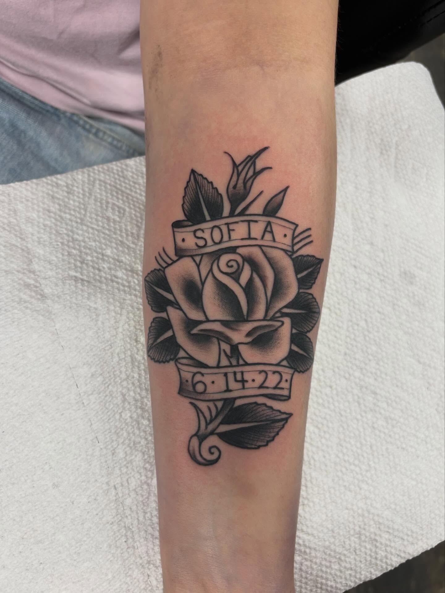 Rose with banner American traditional tattoo on the forearm by Nolan Croteau