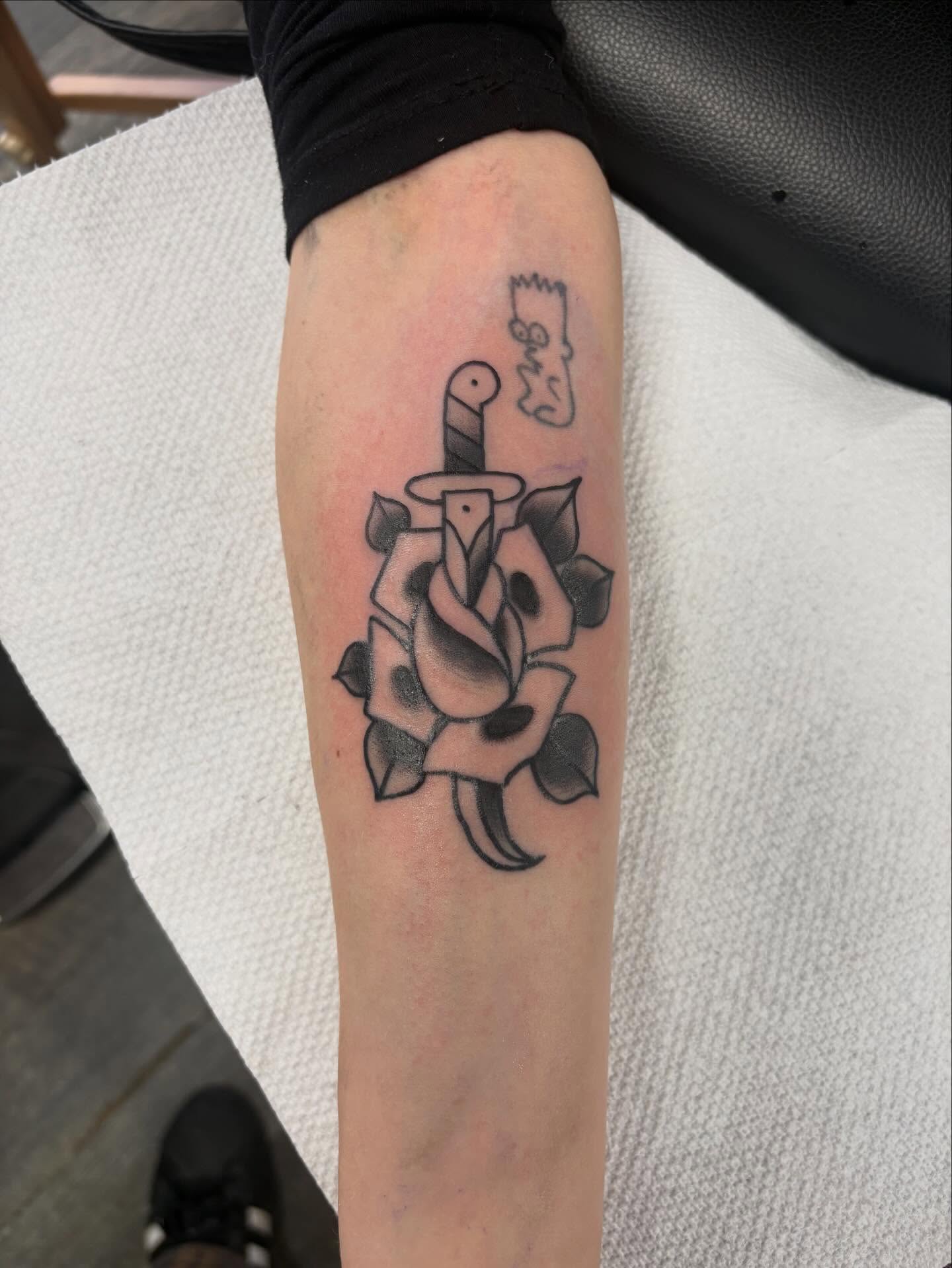 Rose and dagger black and grey tattoo on the forearm by Nolan Croteau