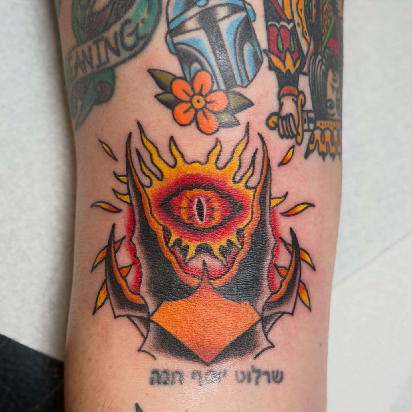Flaming eye American traditional tattoo on the forearm by Trevor Berry