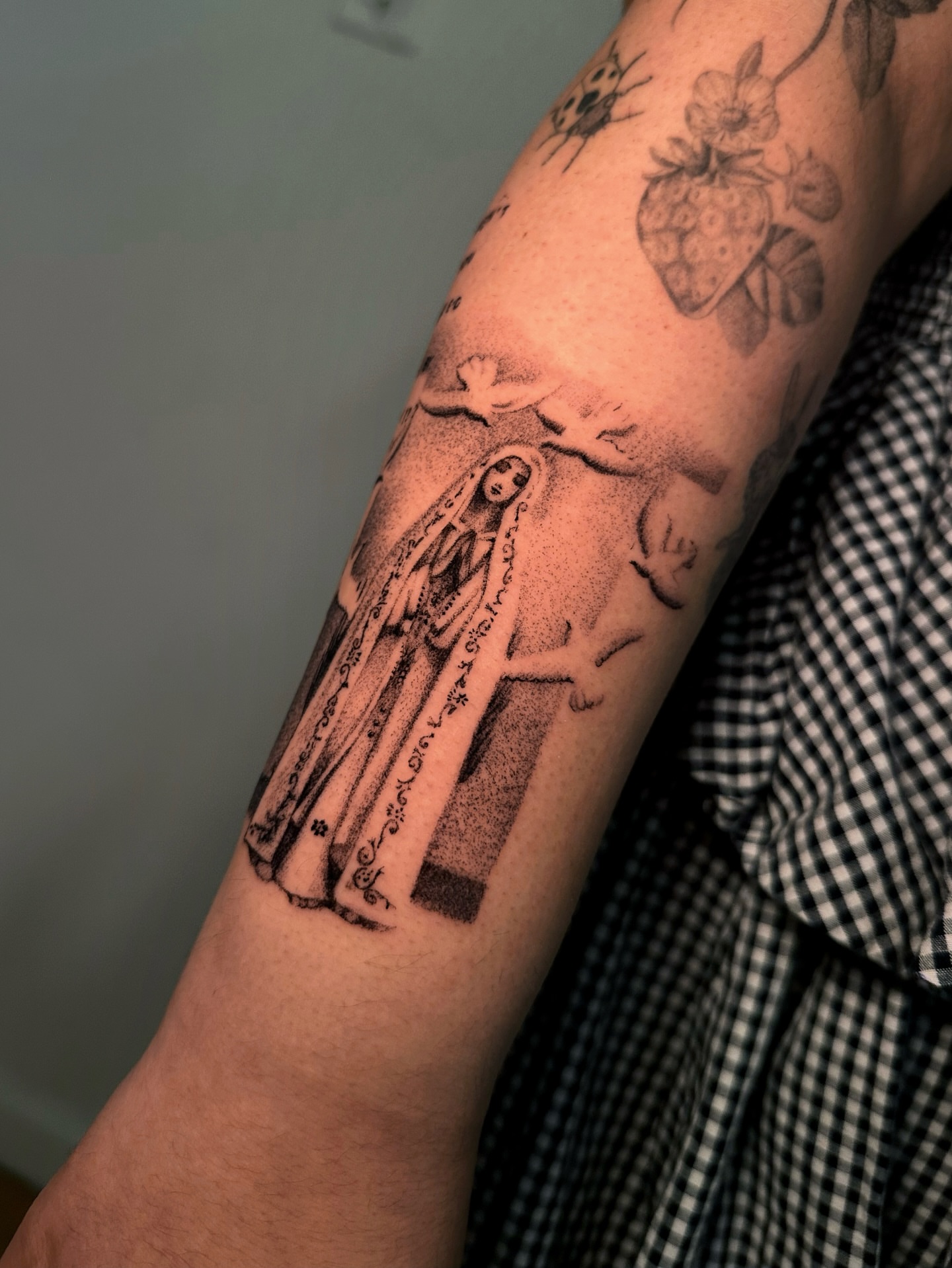 Religious figure dotwork tattoo on the forearm by kale