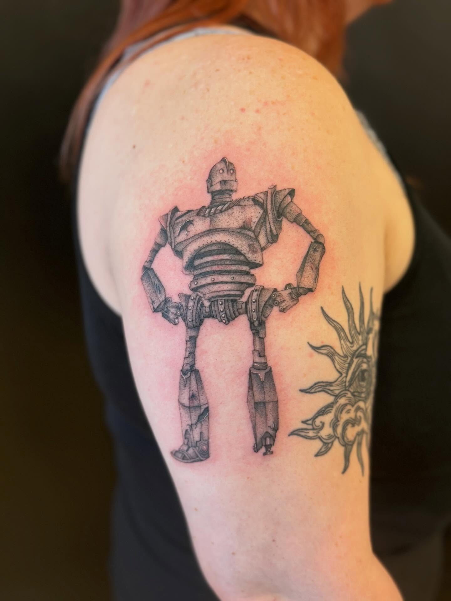 Robot dotwork tattoo on the shoulder by Dre