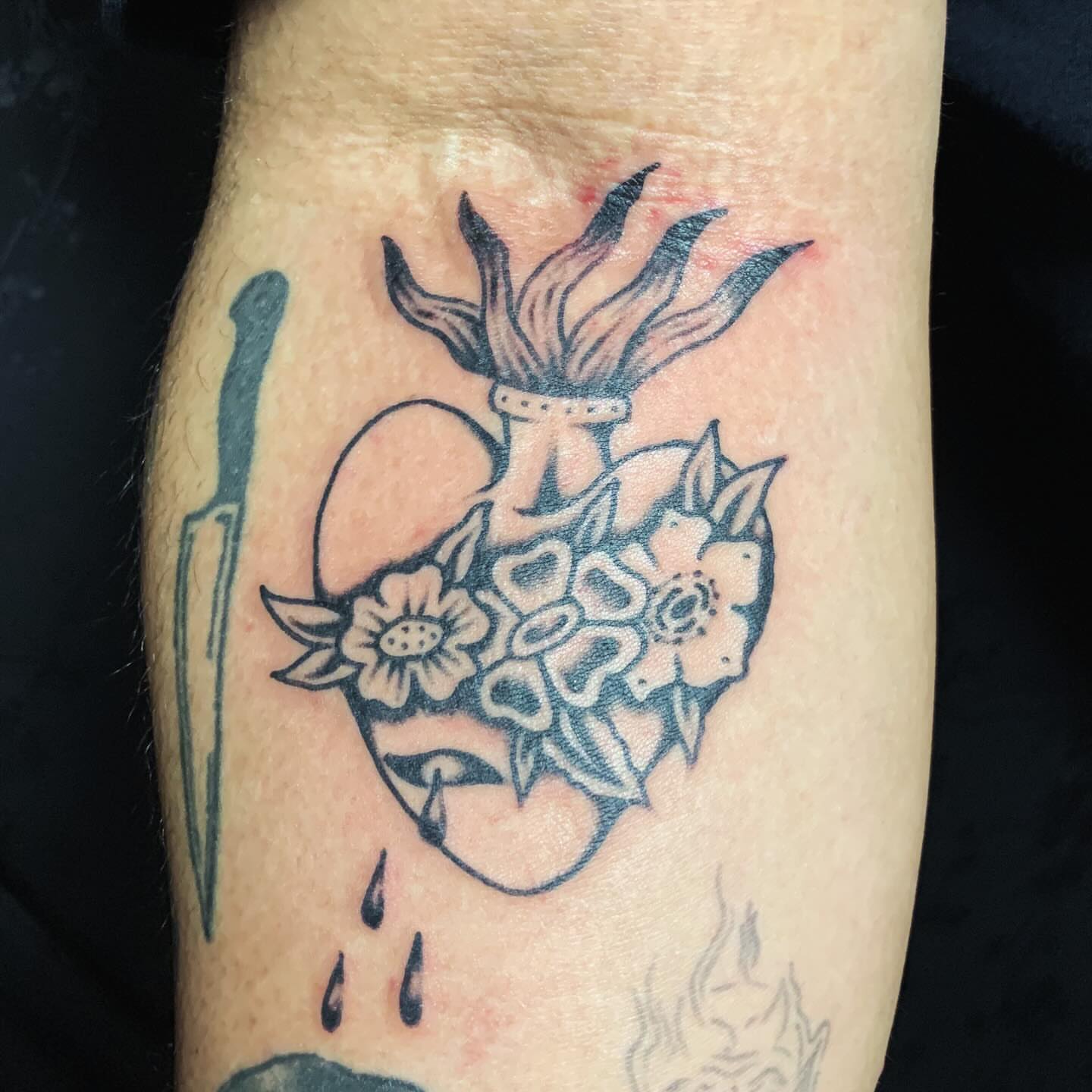 Heart with flowers black and grey tattoo on the forearm by Brii Moser