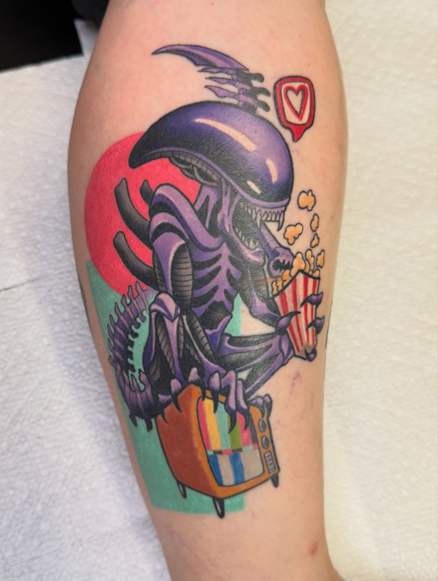 Alien eating popcorn new school tattoo on the forearm by Pat Patterson Florida Tattoo Artist